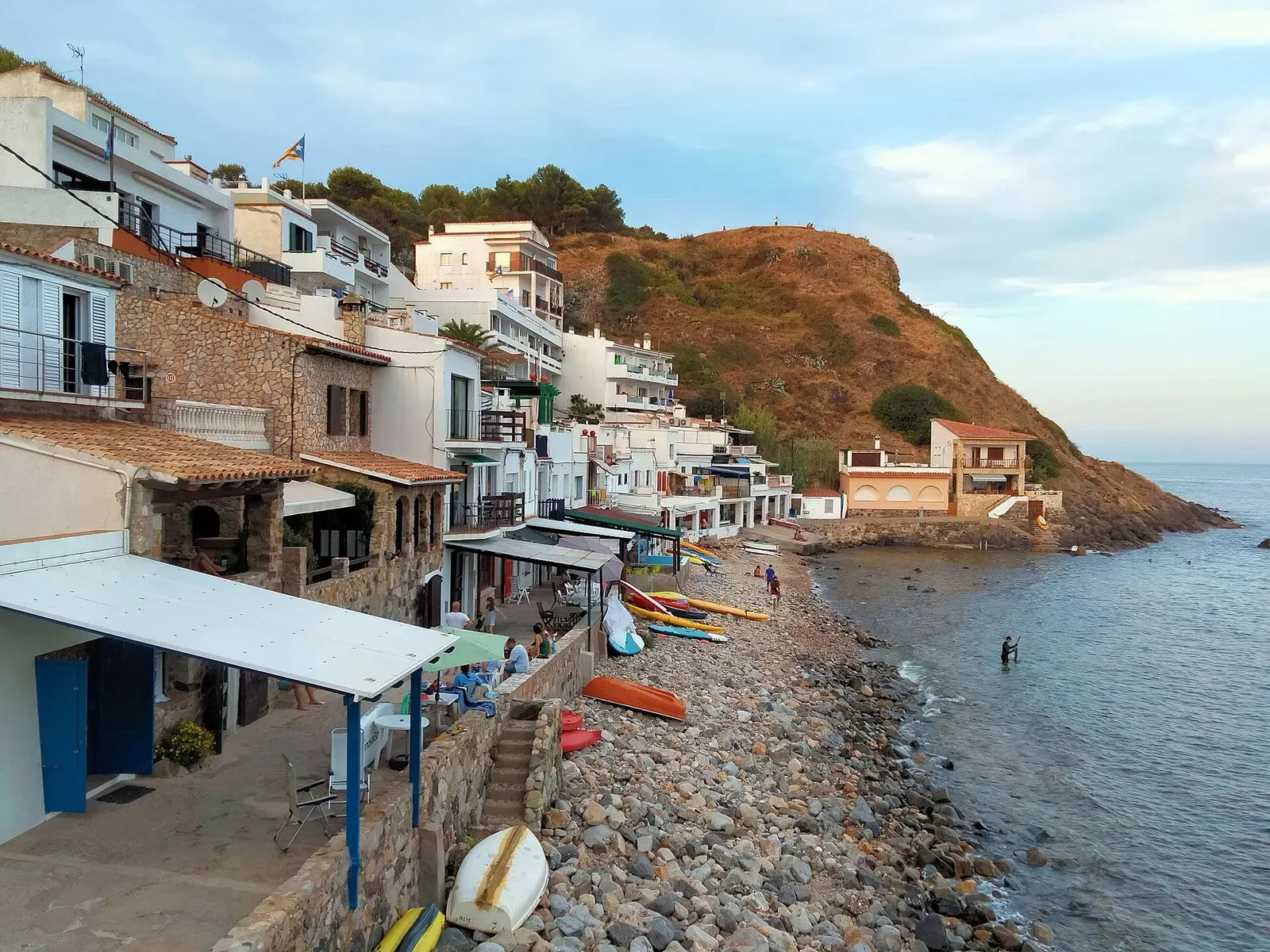 Waterfront houses along the rocky shore at Cala Margarida