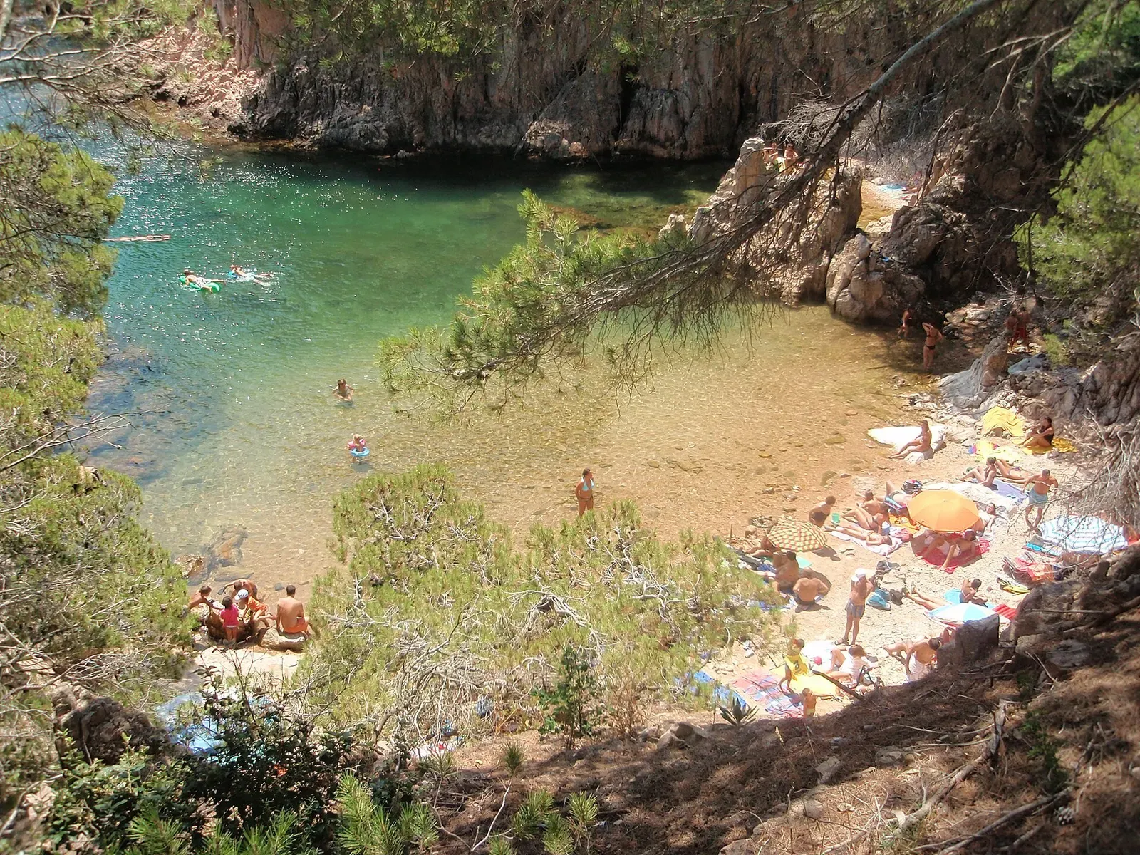 Swimmers on the small beach at Cala d'Aigua Xelida