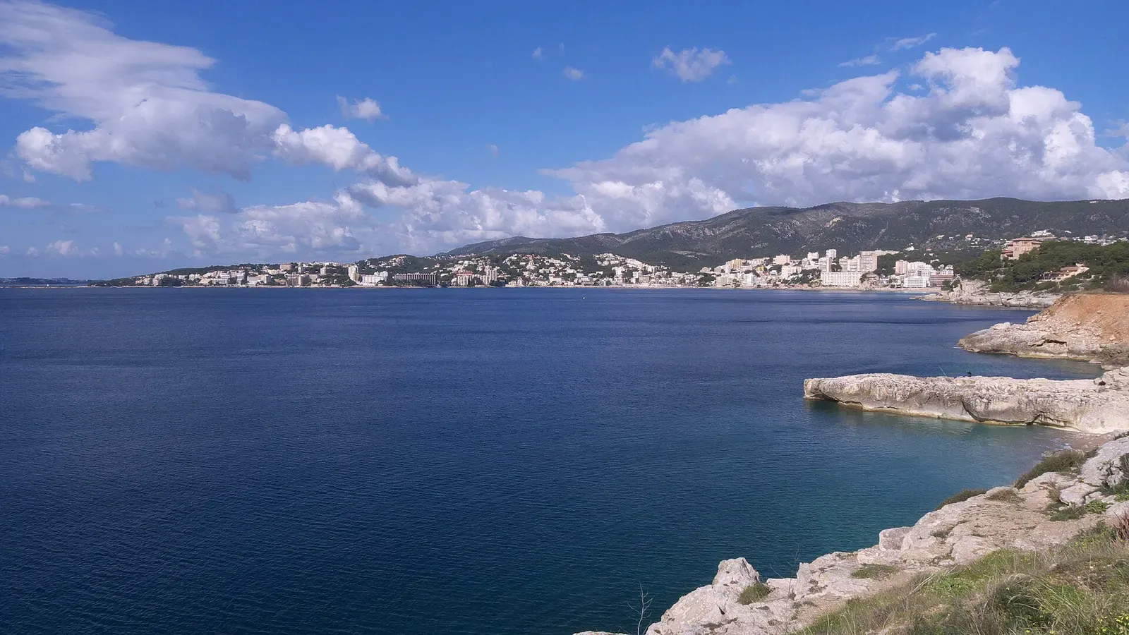 Panoramic view of the Cala Major coastline near Palma with calm blue water and low cliffs