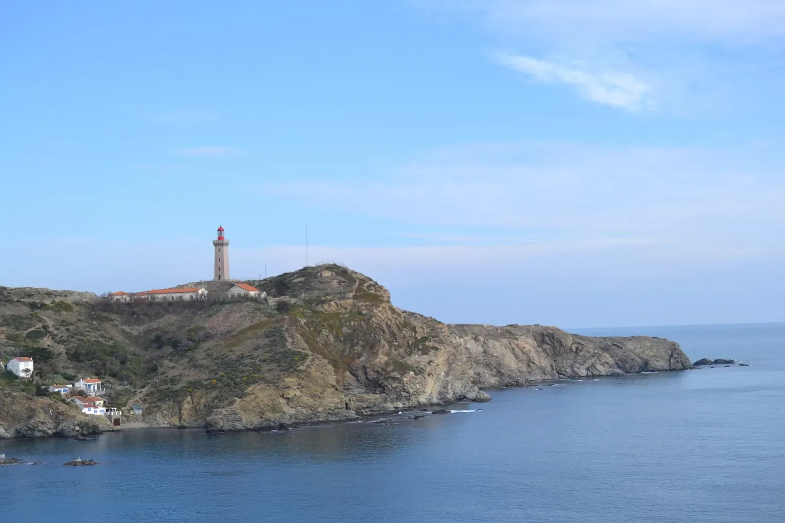 Cap Béar lighthouse on its rocky headland seen from the sea