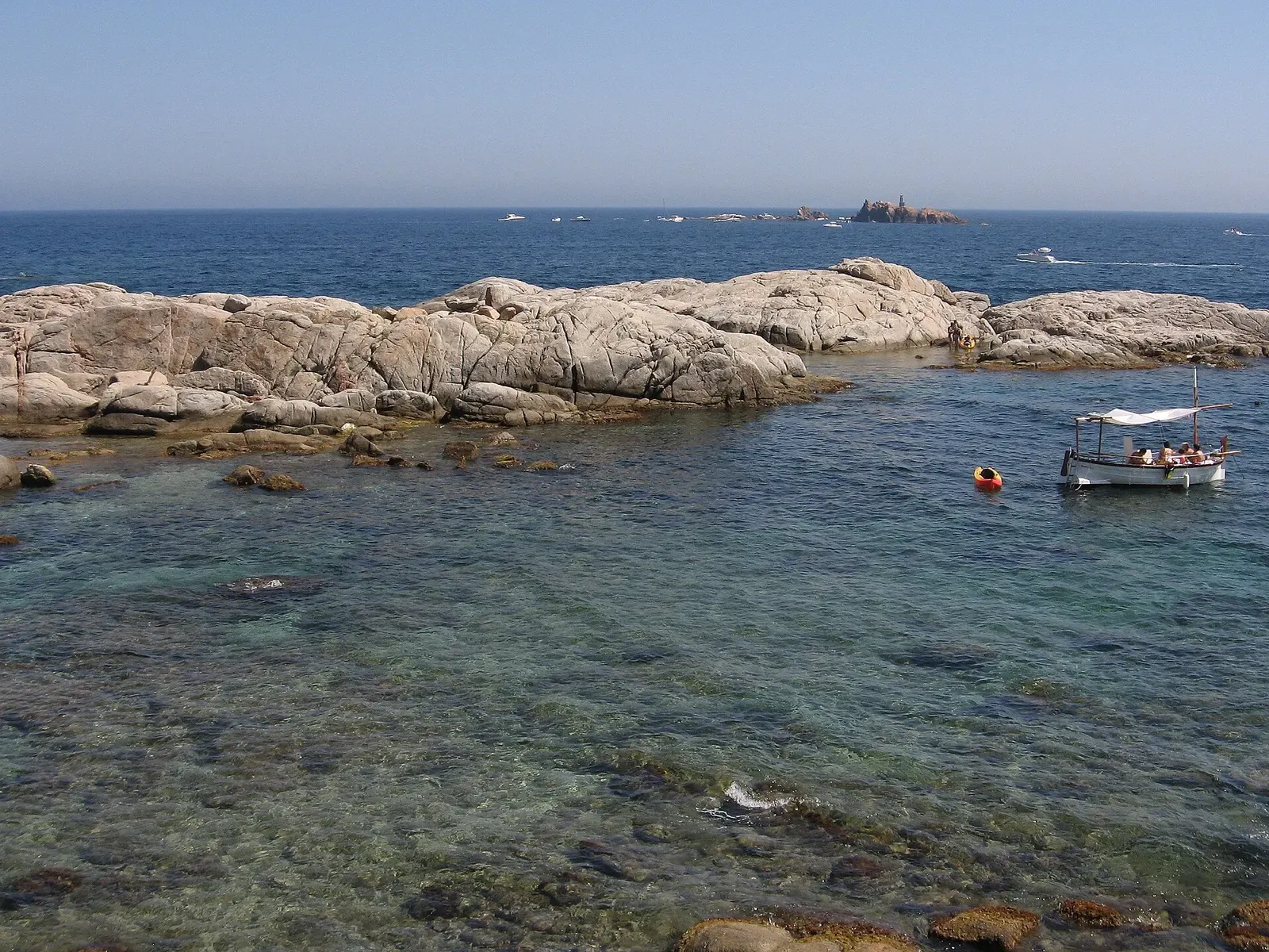 Clear shallow water over rock near Cap de Planes and the Illes Formigues