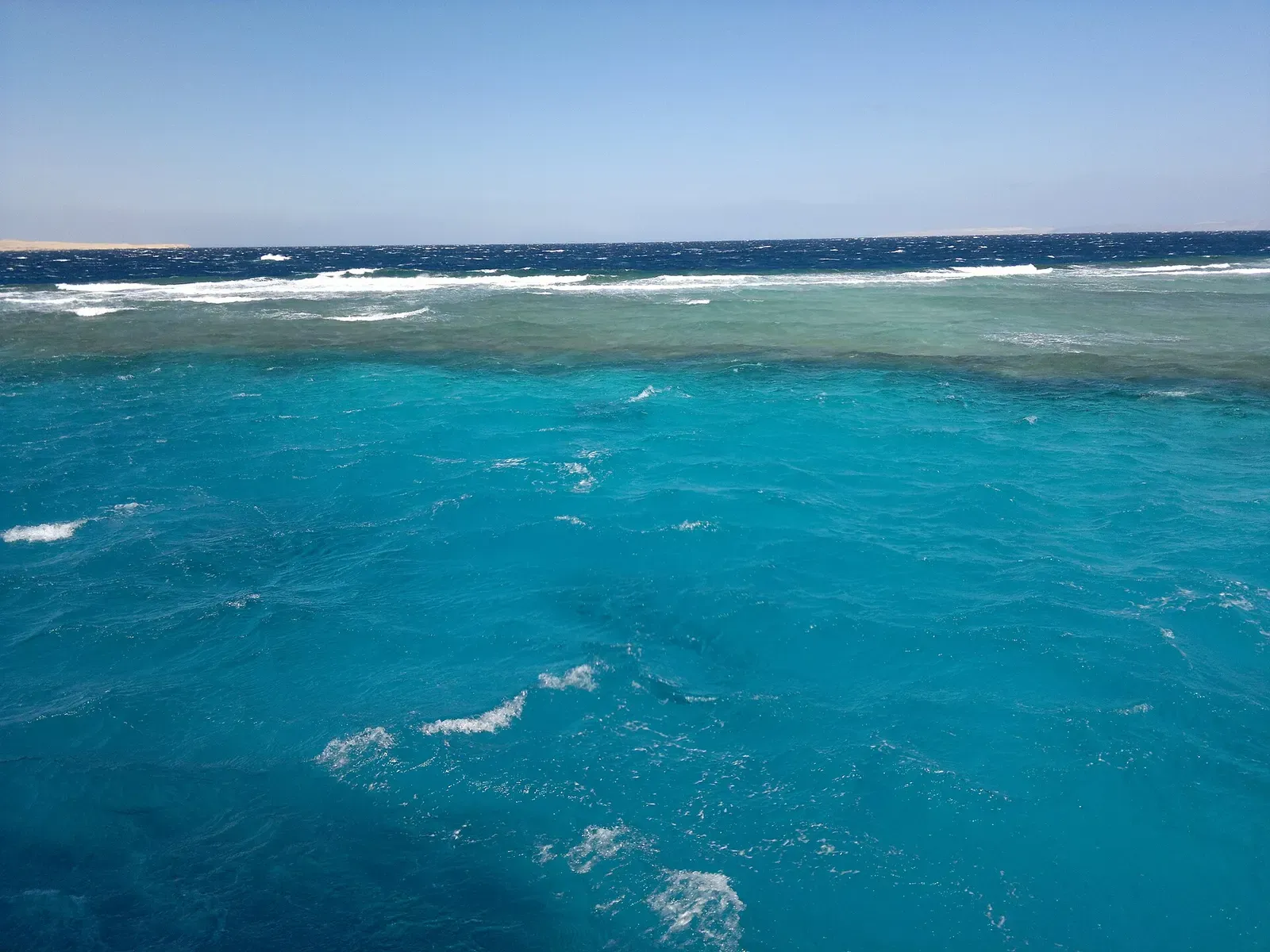 A shallow coral reef flat meeting turquoise water off Hurghada — Giftun Islands