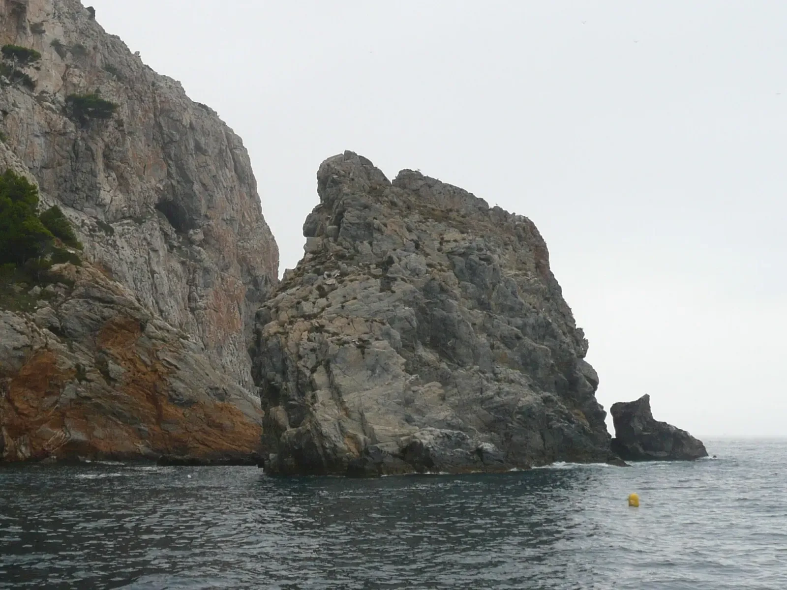 El Gat sea stack at Cap Norfeu, its rock pillar rising from the water on the west side — Cap de Norfeu, Cap de Creus