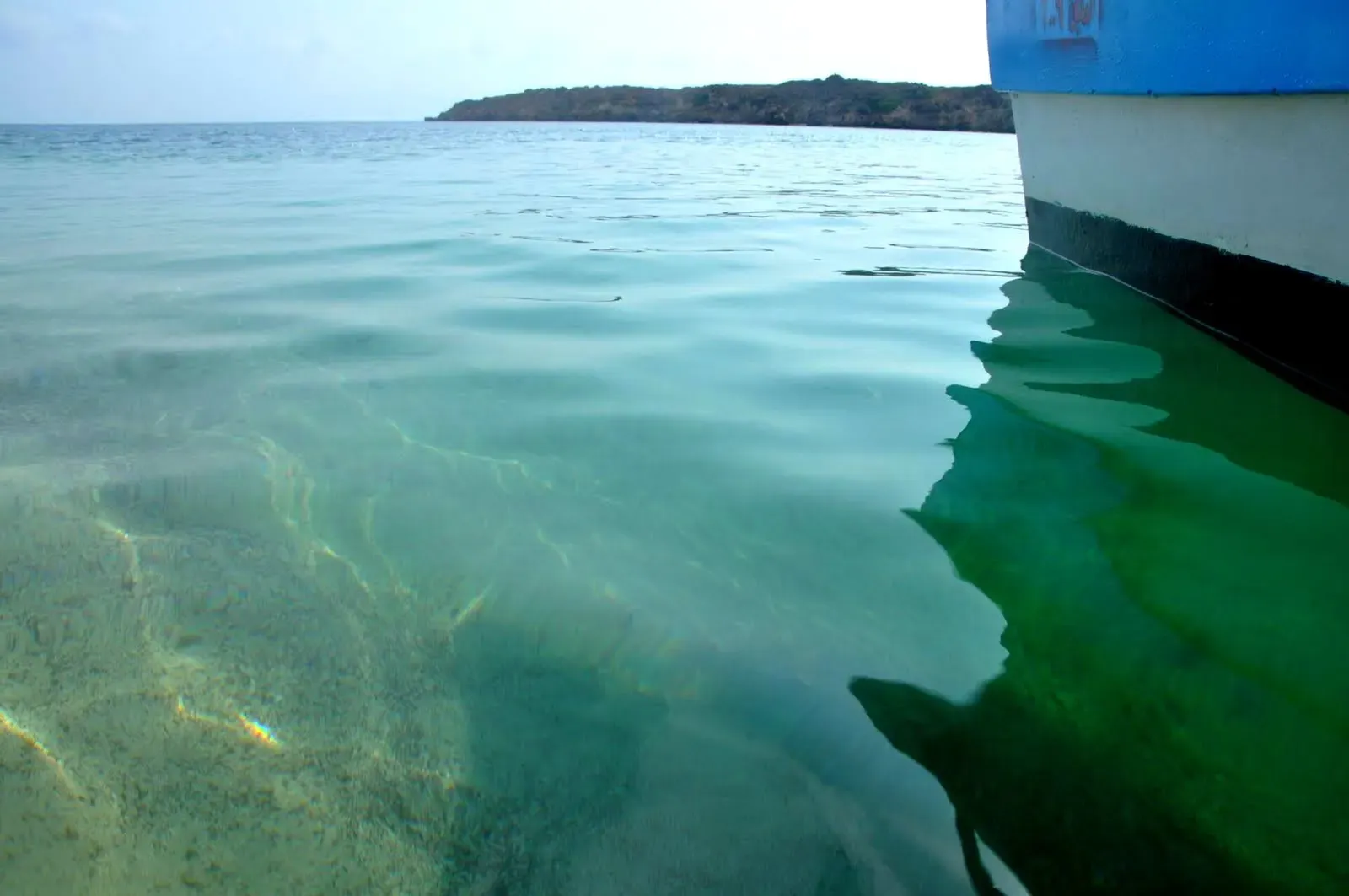 Clear green shallows over a coral flat seen from the bow of a boat off Farasan Island — Farasan Kebir, Farasan Banks