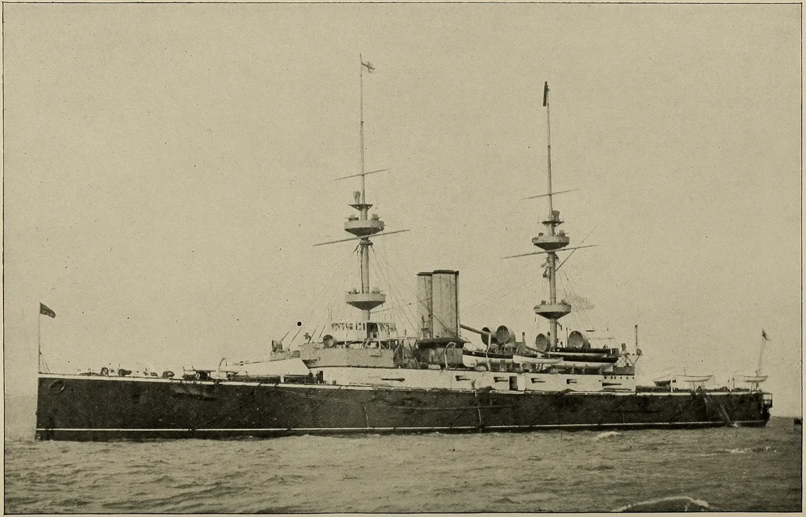 A late-1890s photograph of the pre-dreadnought battleship HMS Majestic under way, two funnels and heavy masts — Gallipoli.