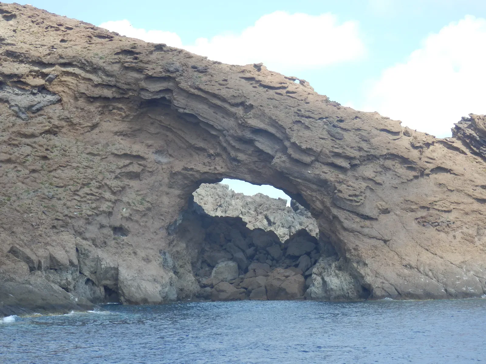 Natural arch cut through the volcanic rock of a Columbretes islet — Islas Columbretes