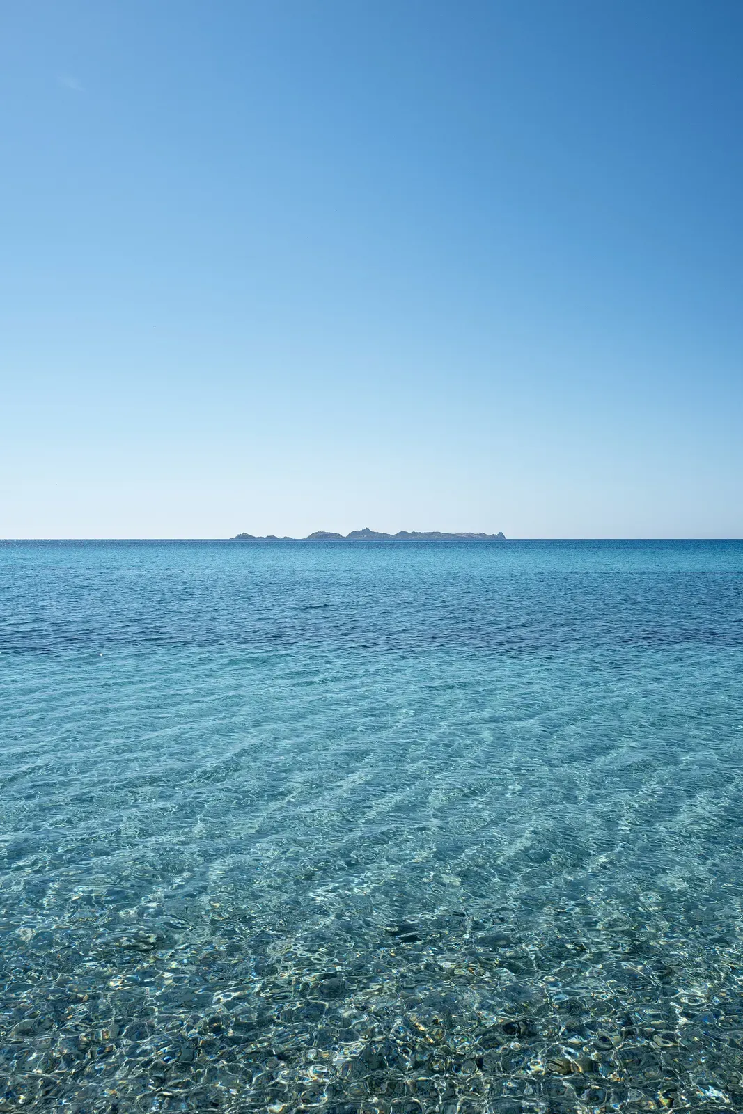 Clear turquoise water with the Variglioni and Serpentara islets on the horizon — Capo Carbonara
