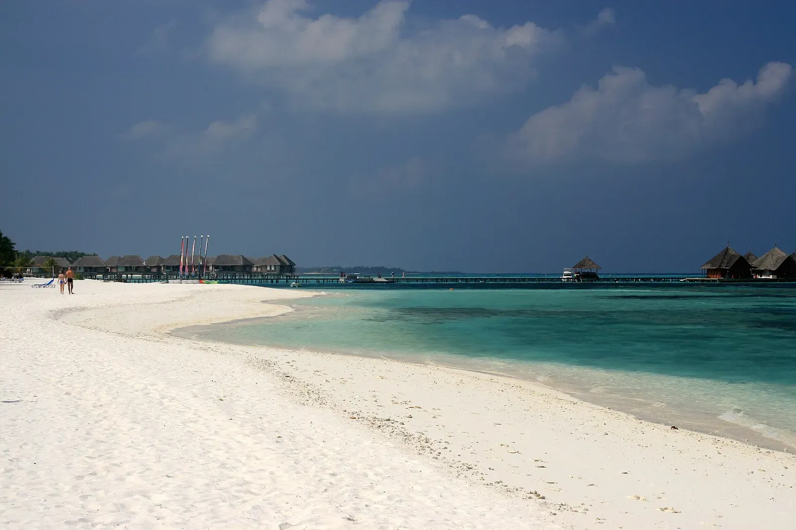 White sand beach and overwater bungalows fronting the lagoon on Kani island