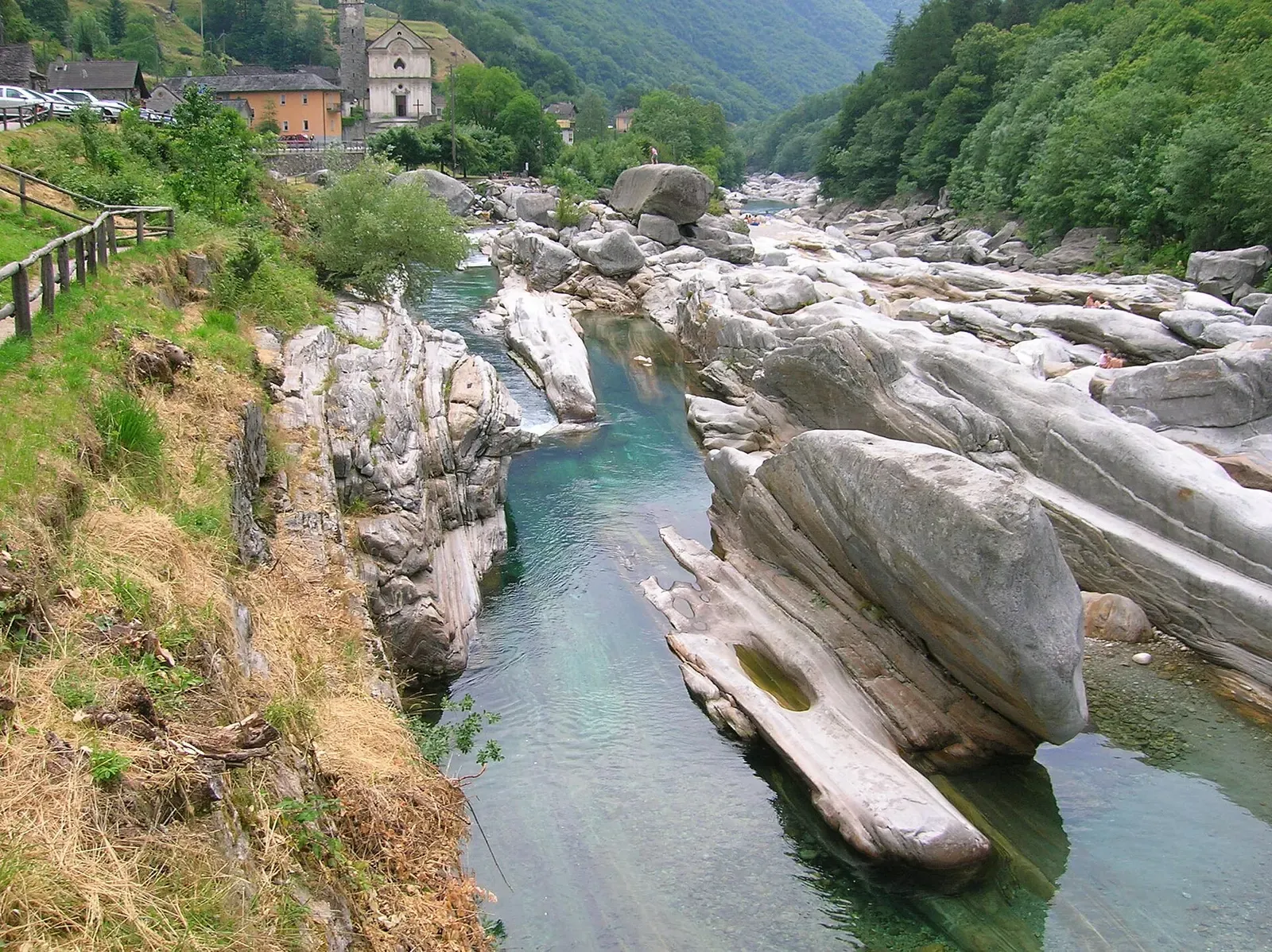 Clear turquoise channel of the Verzasca river winding between smooth granite boulders at Lavertezzo — Verzasca Valley
