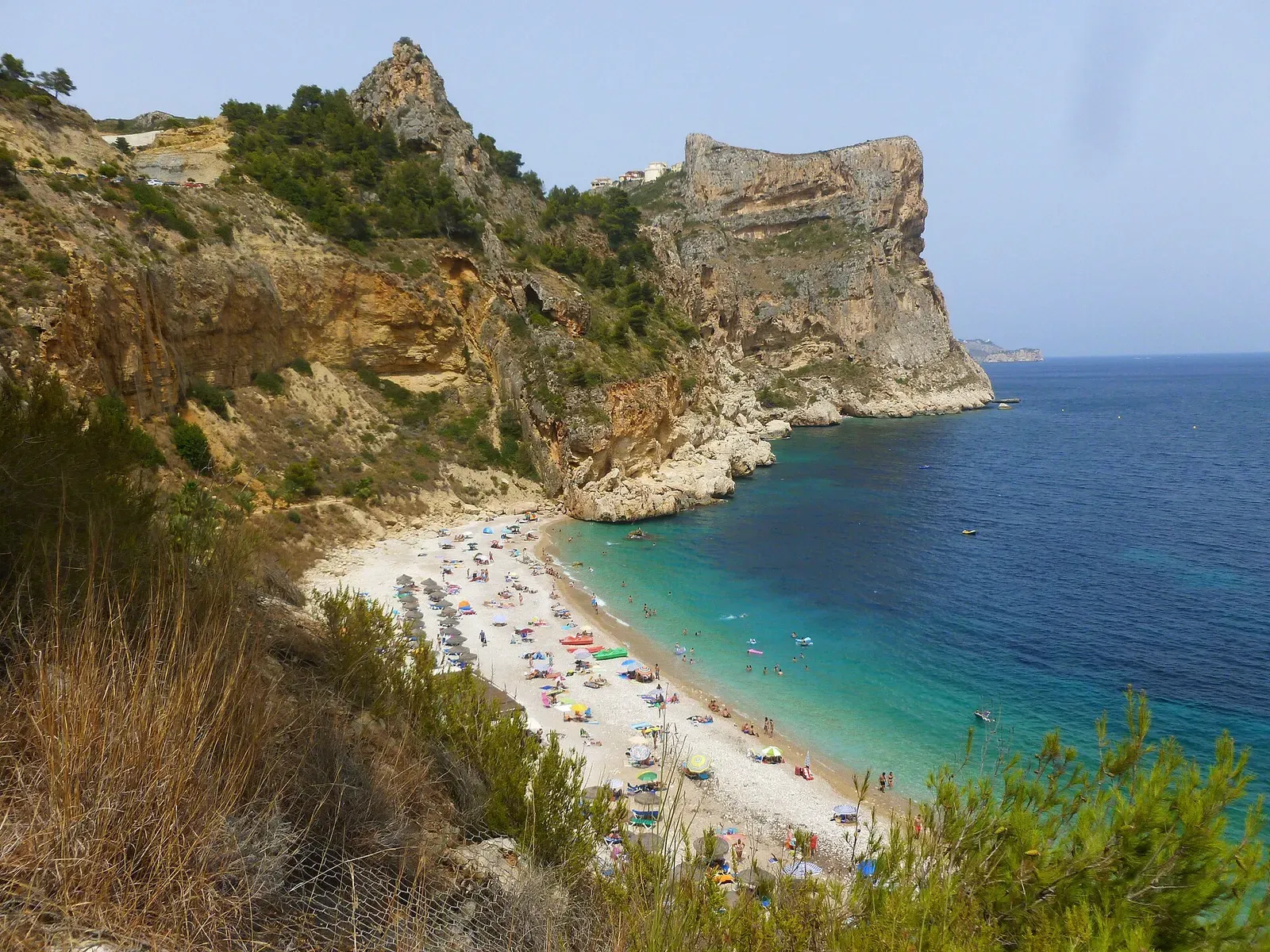 Rocky cliffs above a small pebble cove at Moraig on the Costa Blanca
