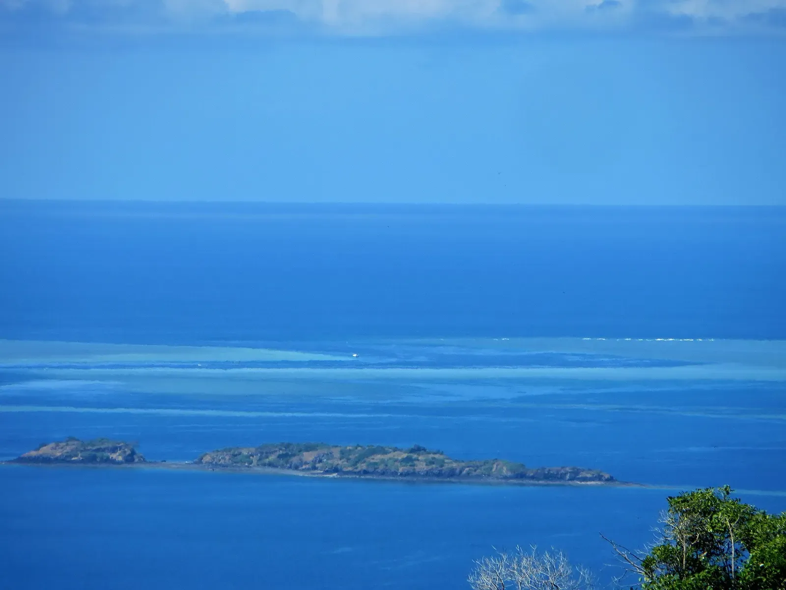 View of the Passe en S reef pass and lagoon from the hills above Mayotte