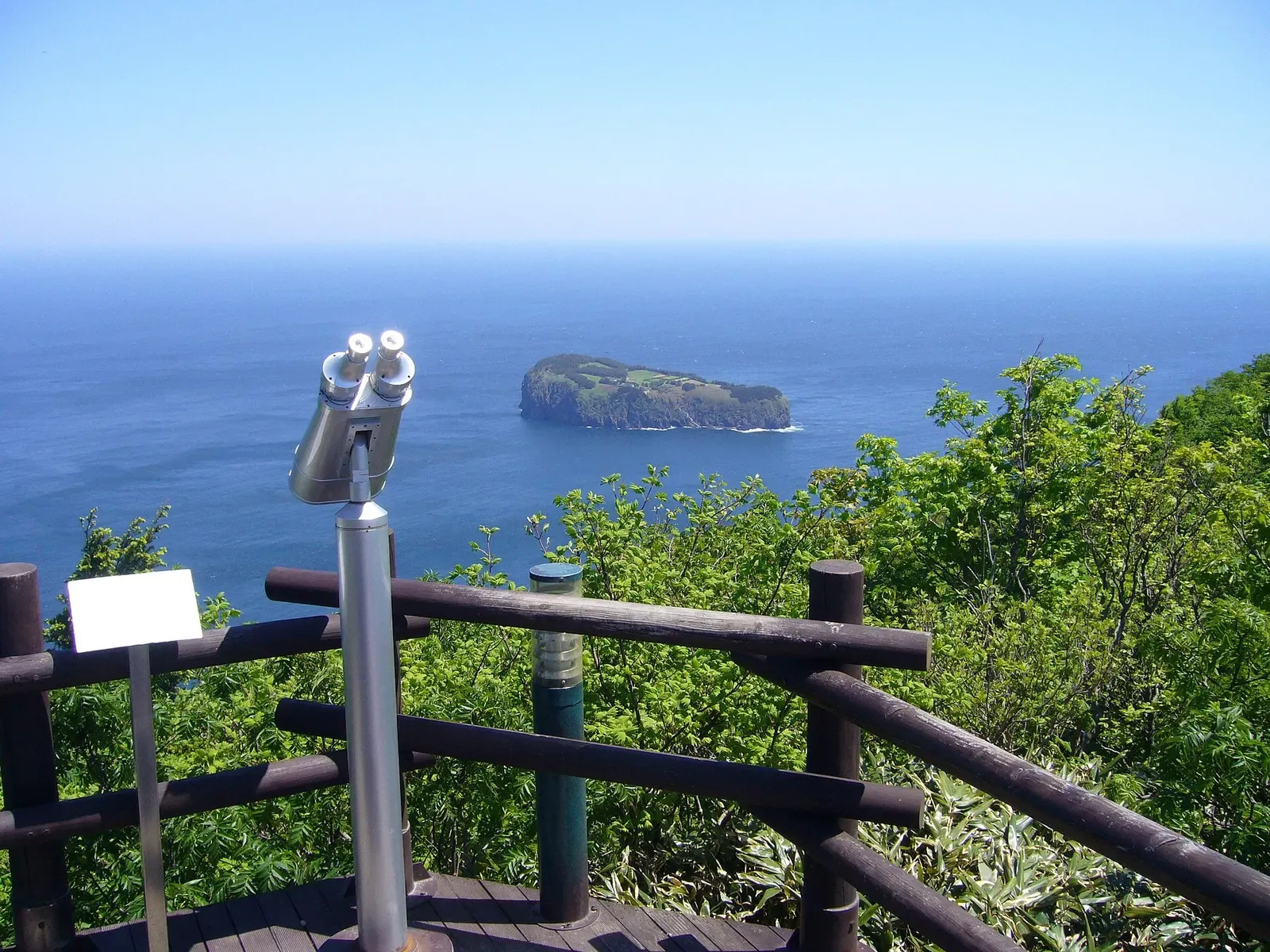 Jukdo islet viewed across open water from Ulleungdo's Sunrise Observatory, framed by an overlook railing