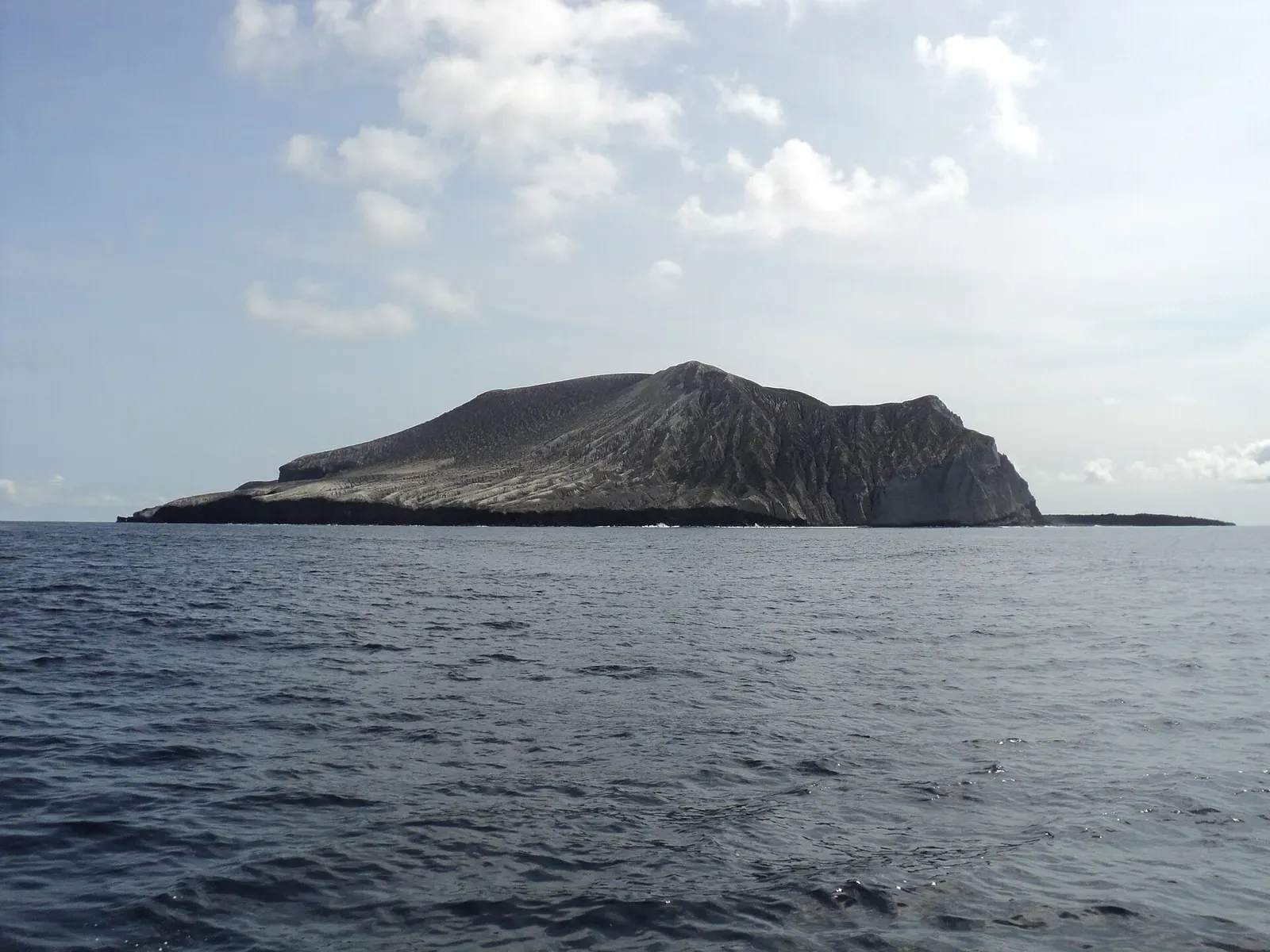 San Benedicto Island's volcanic cone seen from a dive boat on a clear day — El Boiler, Socorro Island.