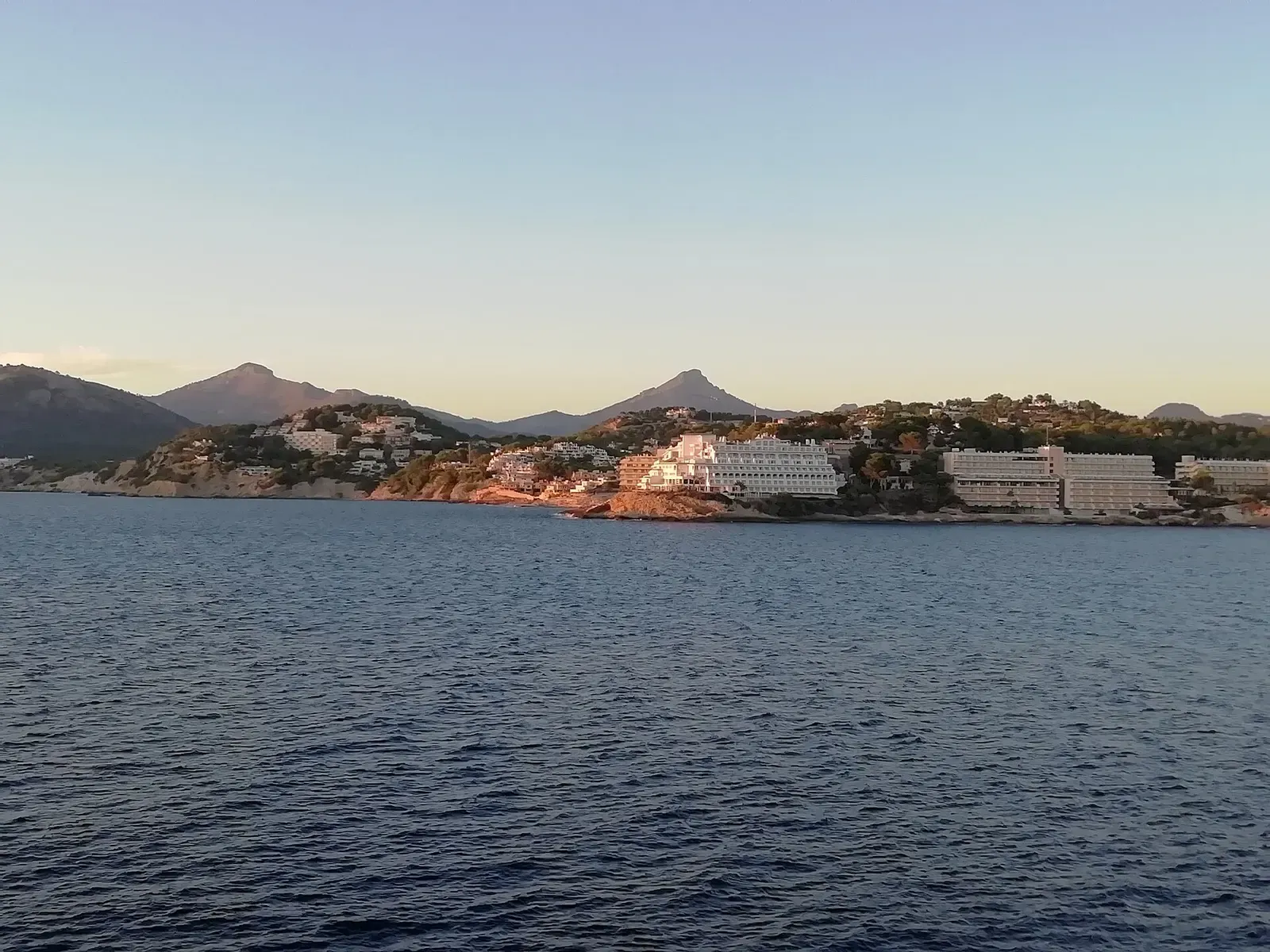 Wide view of Santa Ponça's bay and hillside town from above