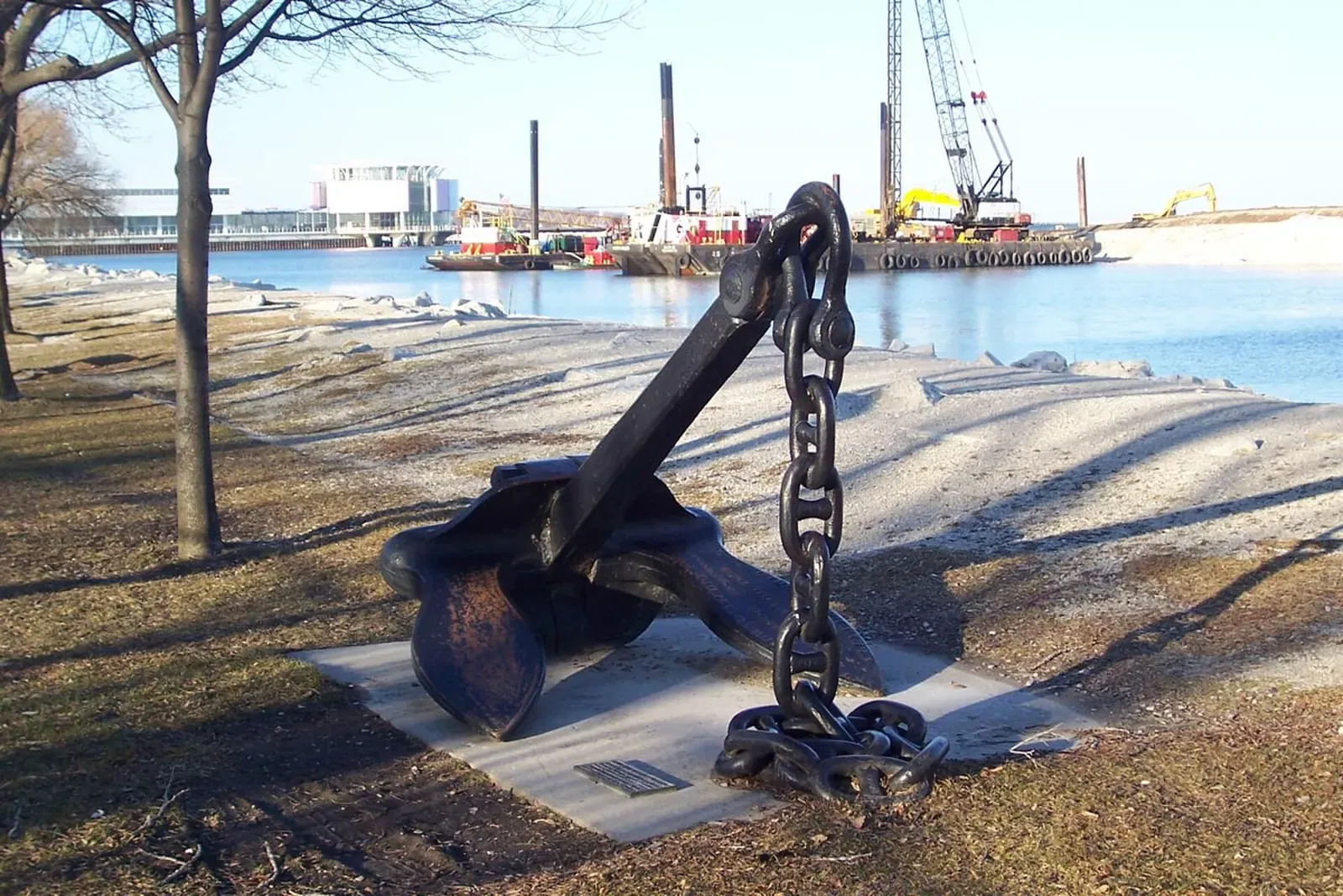 Large iron ship anchor and chain displayed on a concrete pad by the Milwaukee waterfront — Milwaukee Car Ferry