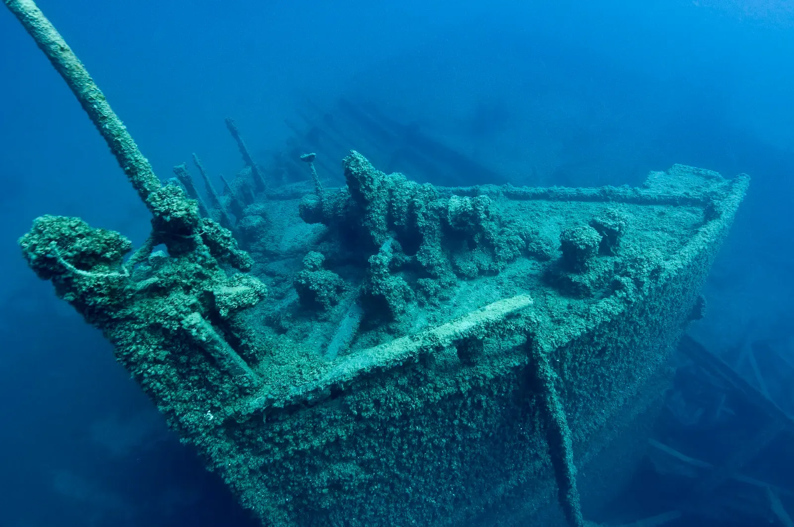Green-hued view of the Grecian's deck structure encrusted with algae on the lake floor — Thunder Bay