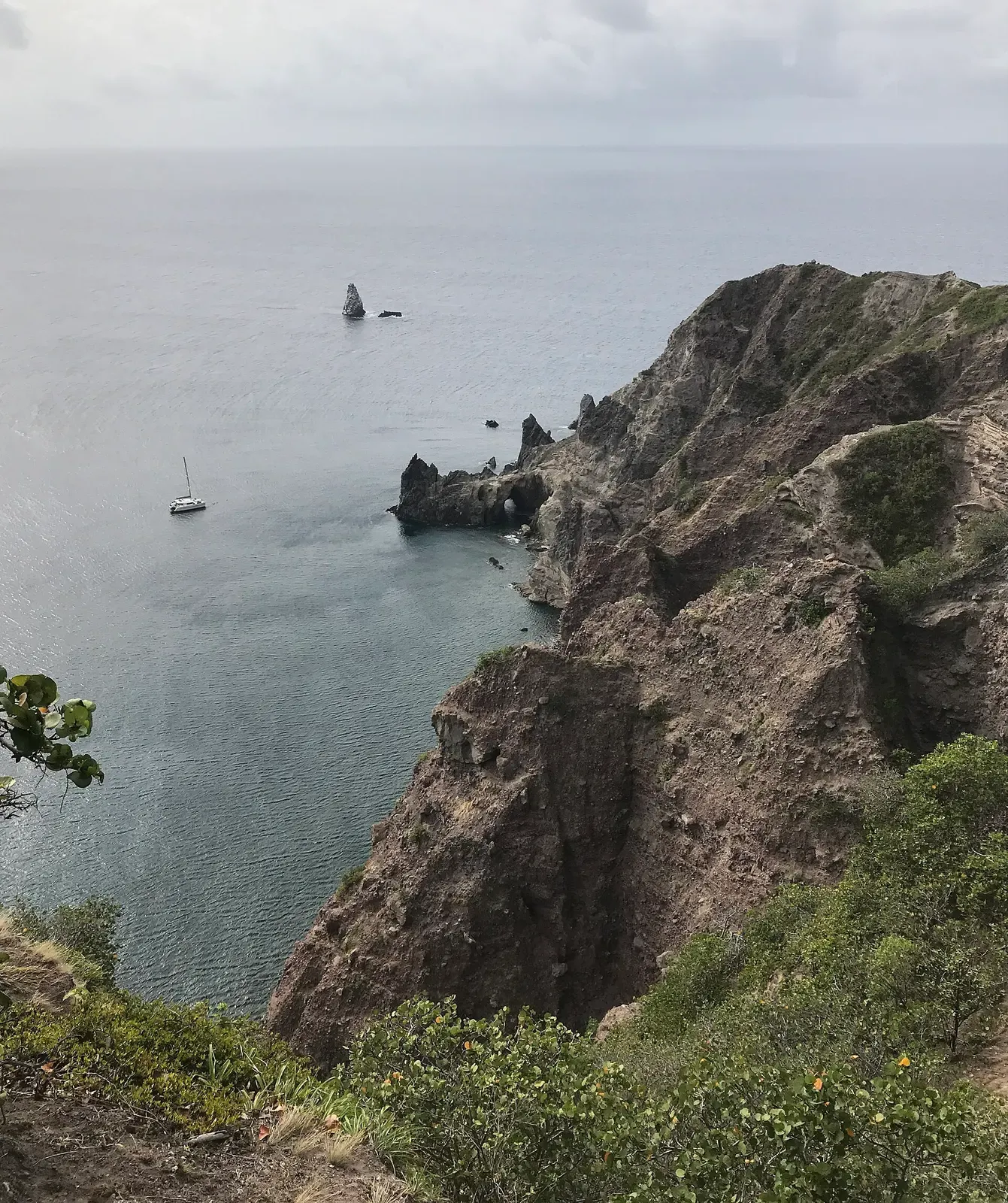 Elevated view of Wells Bay with Torrens Point and Diamond Rock visible offshore — Man O' War Shoals, Saba