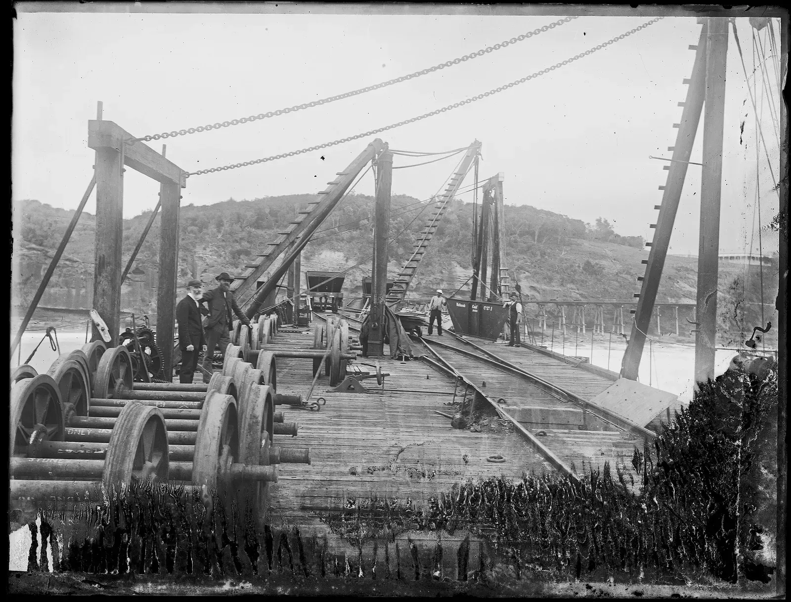 Historic 1894 photograph of workers on the coal loading jetty with its winding gear and rail hoppers