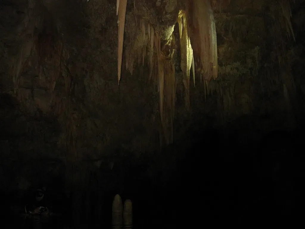 Stalactites hanging in the dark inner chamber of Elephant Cave — Crete