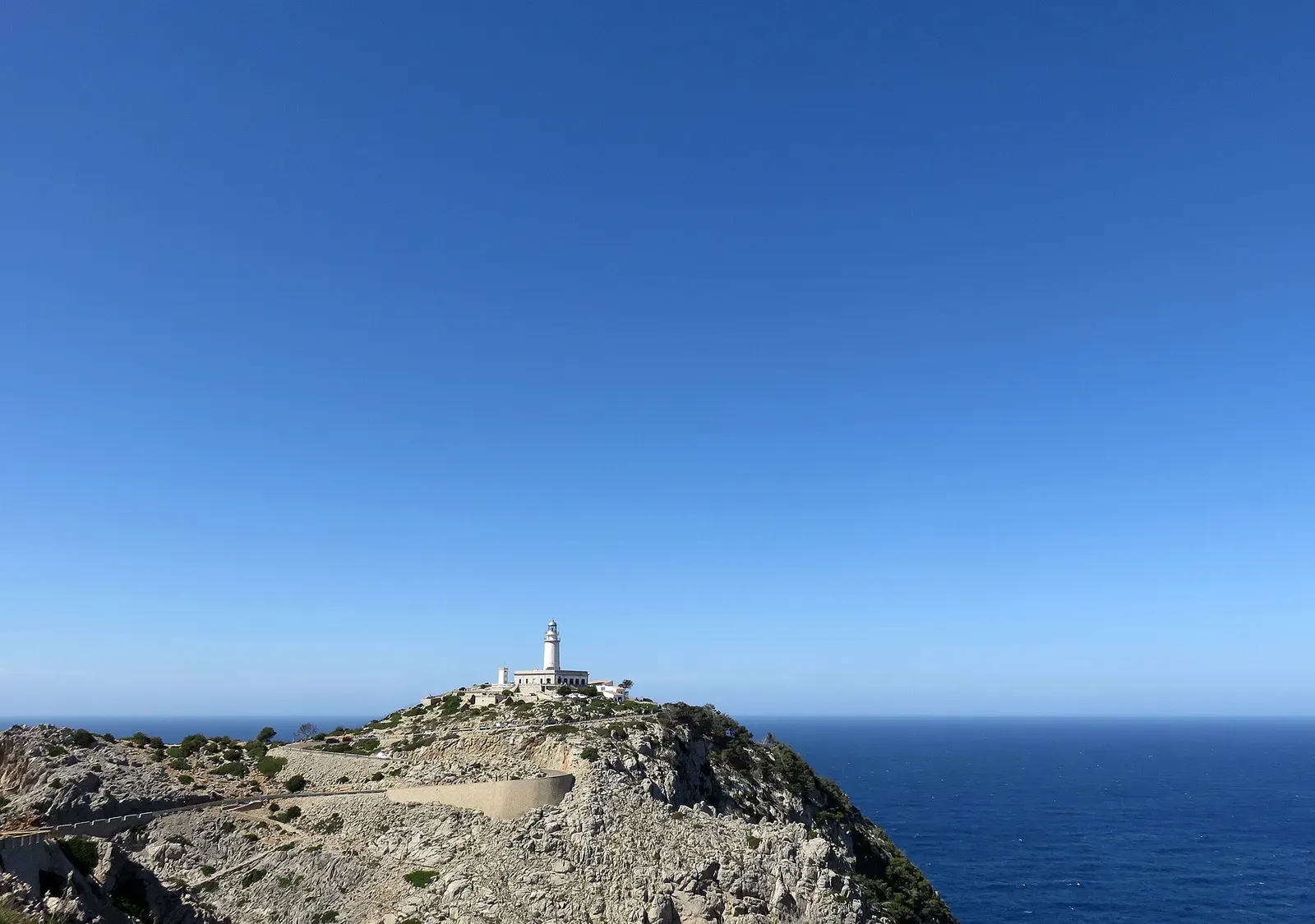 Aerial view of Cap de Formentor's rocky point with the lighthouse perched at its tip