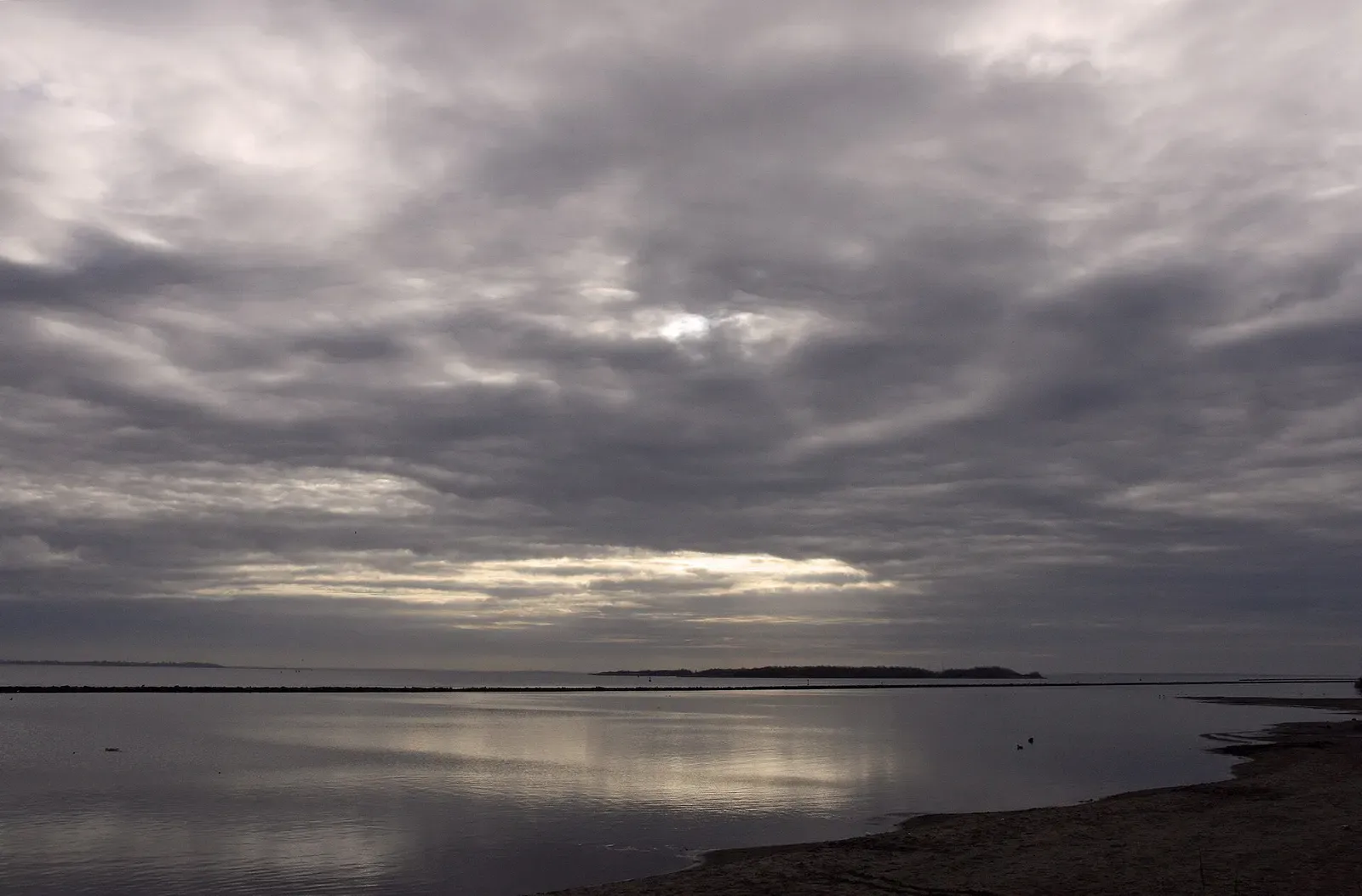 Evening light reflecting on the calm water of the Grevelingenmeer — Den Osse