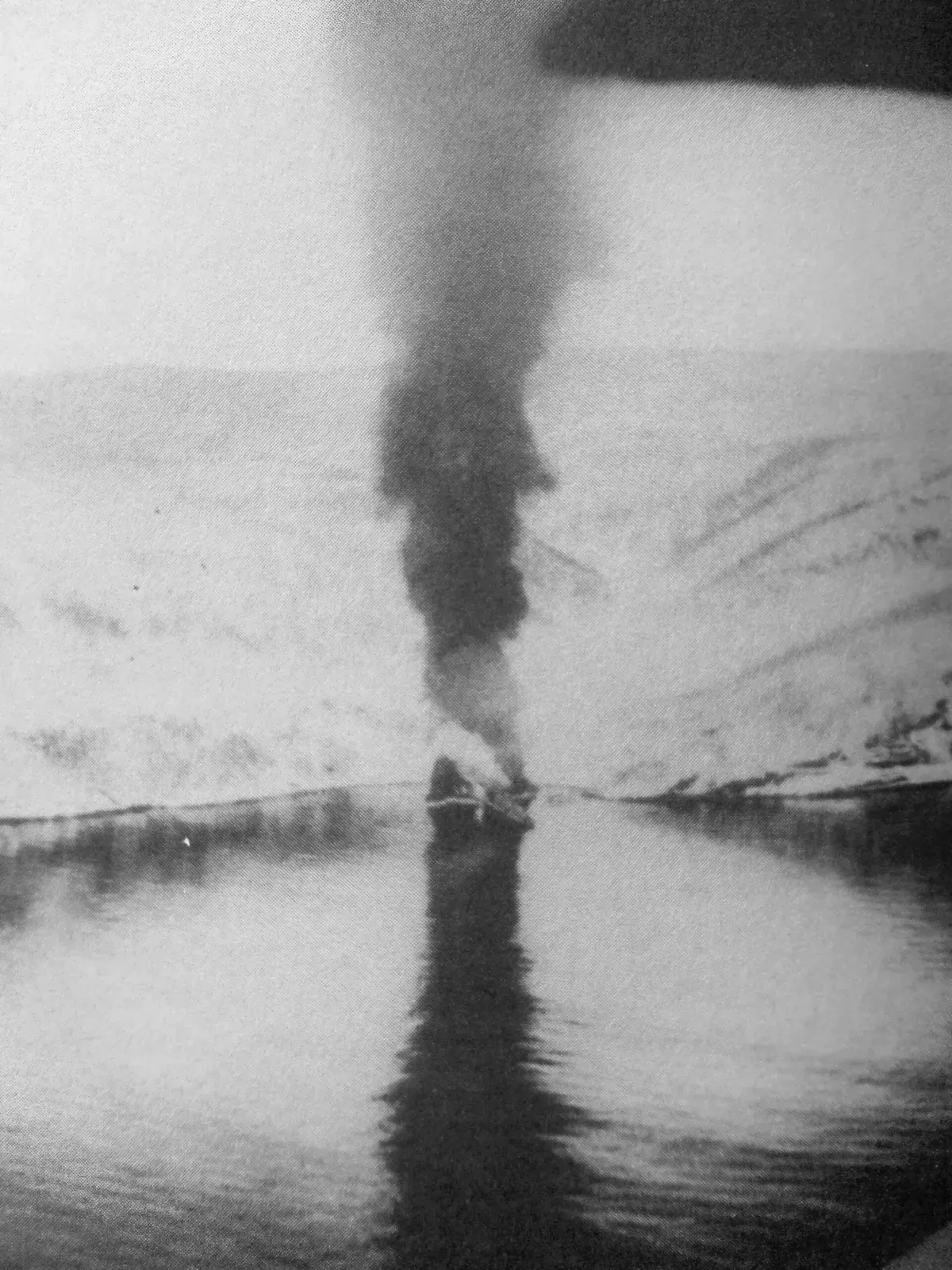 Black-and-white 1940 photograph of the destroyer Hermann Kunne burning in the fjord after being scuttled — Narvik