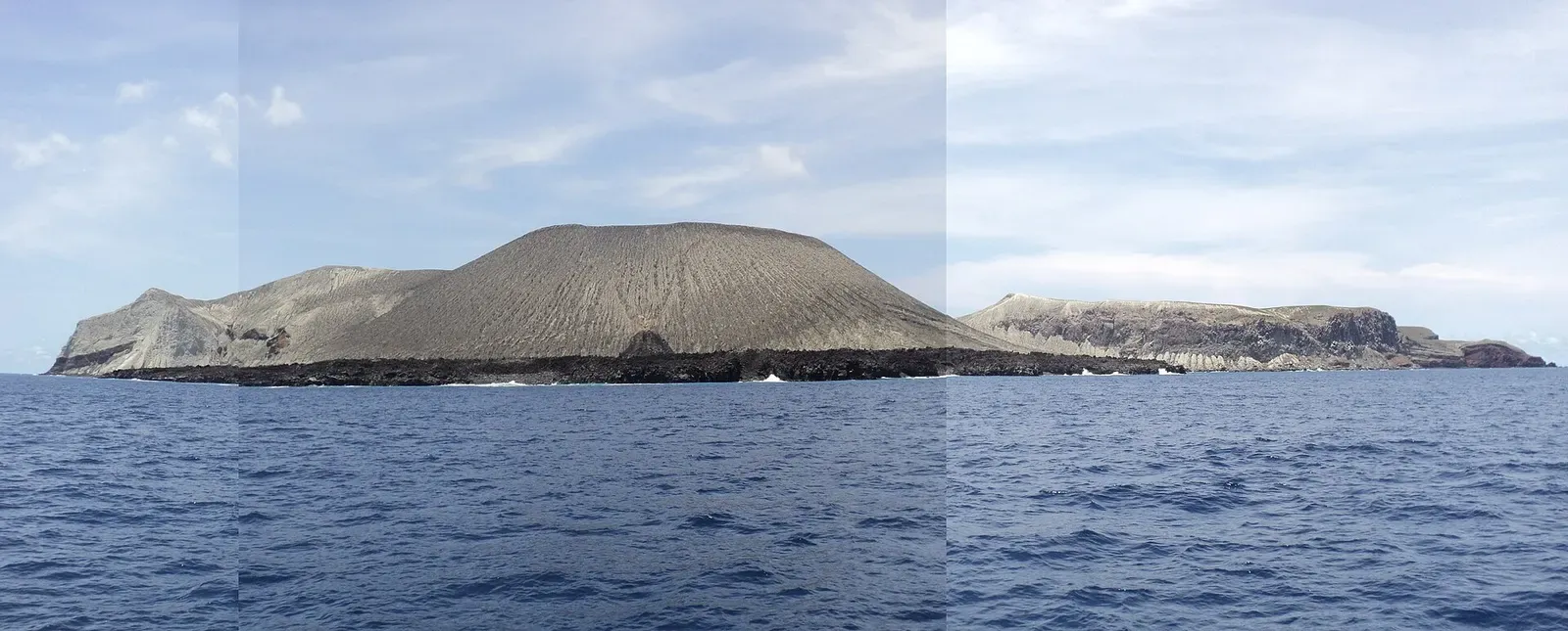 Wide panorama of San Benedicto Island's coastline and volcanic peak — El Boiler, Socorro Island.