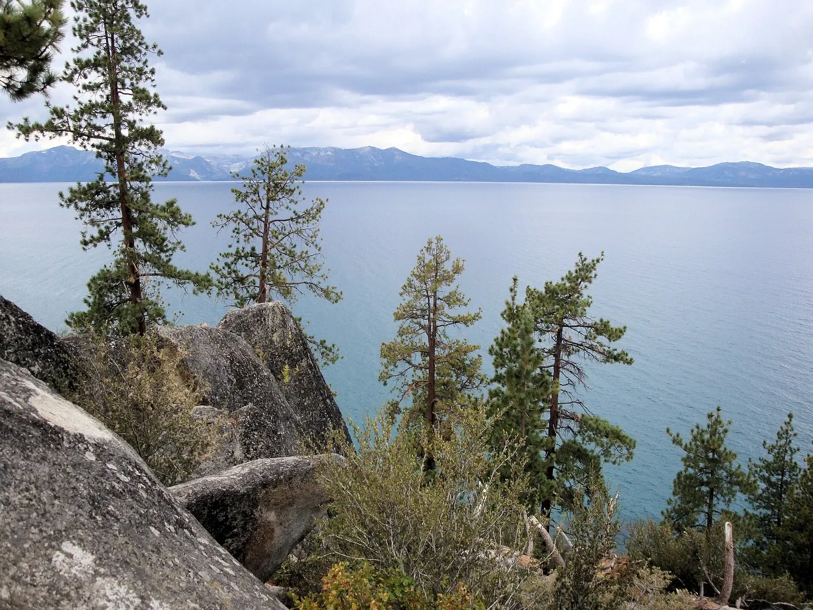 Pines and granite framing the blue expanse of Lake Tahoe