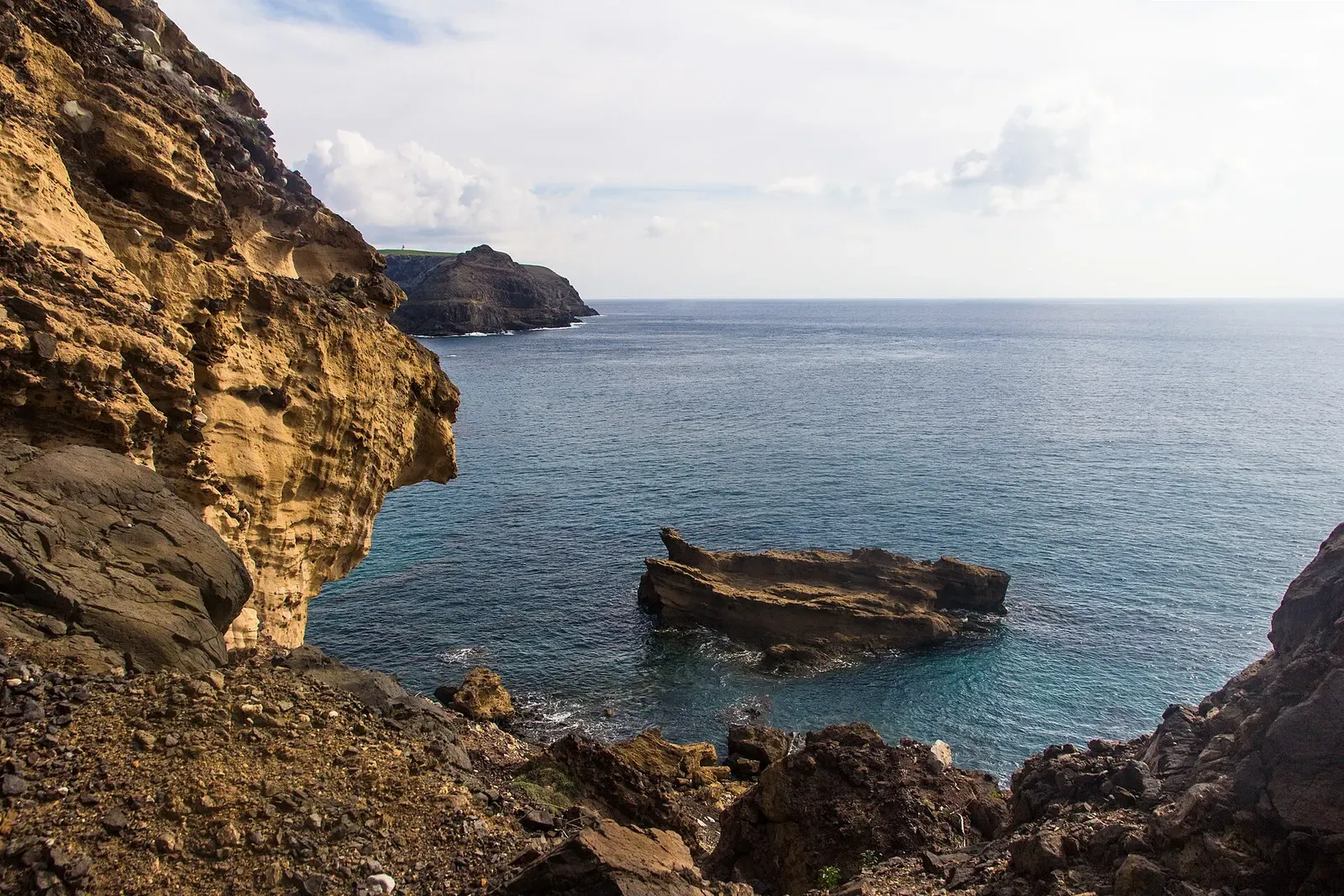 Rugged sea cliffs and an offshore rock stack along Porto Santo's coast
