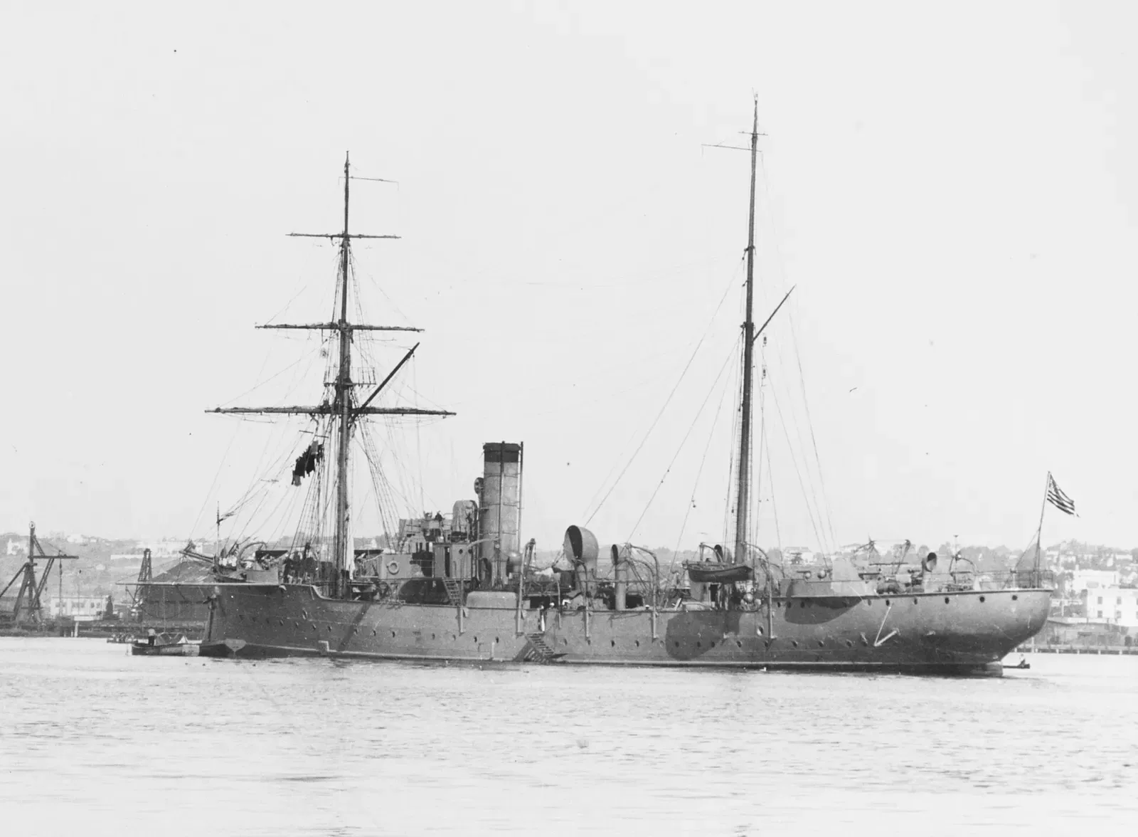 Black-and-white photo of the masted gunboat USS Schurz at anchor in a harbor, American flag flying aft — North Carolina Wrecks.