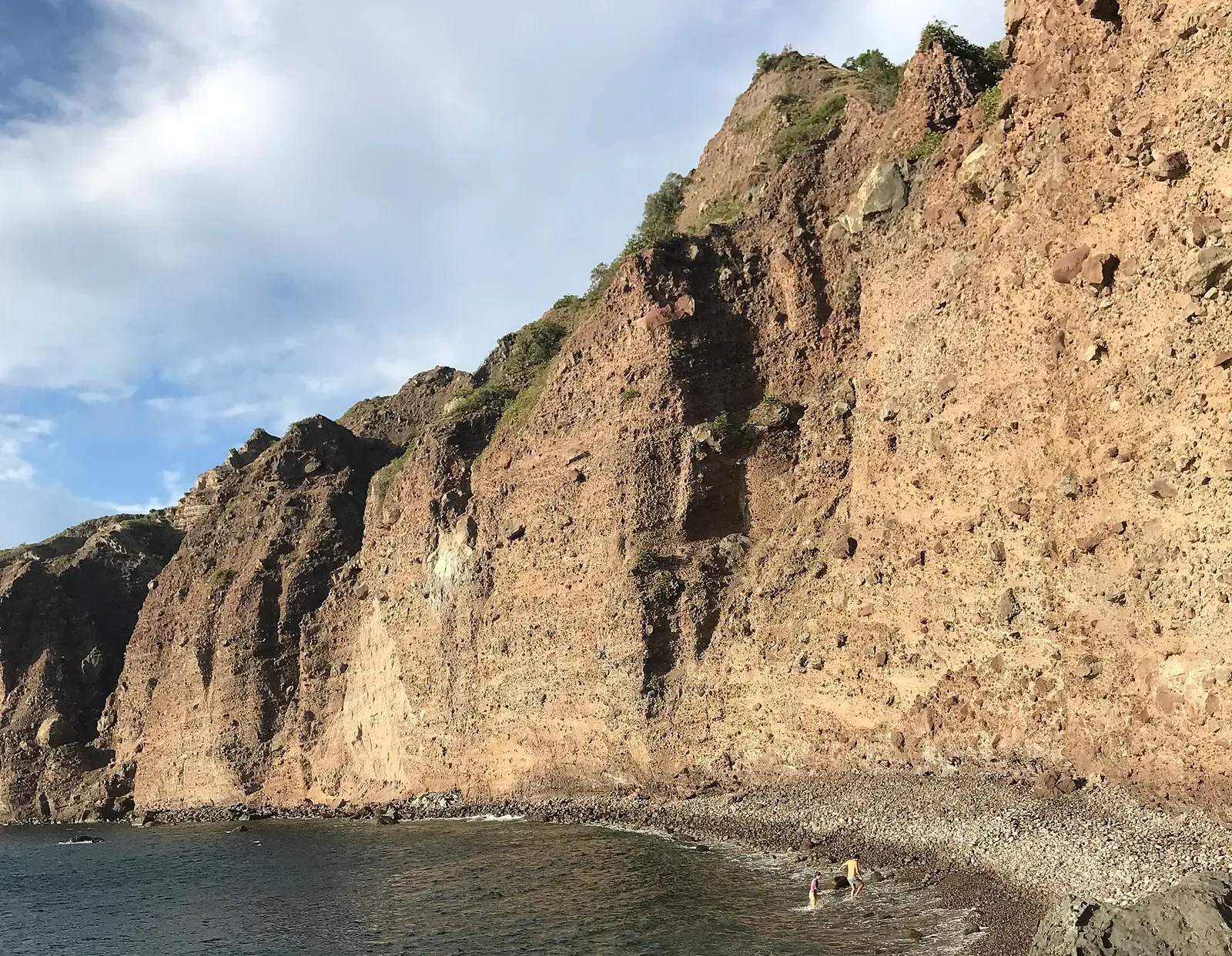 Cobble beach at Wells Bay, the sheltered cove closed off by Torrens Point and the Wells Bay spires — Man O' War Shoals, Saba