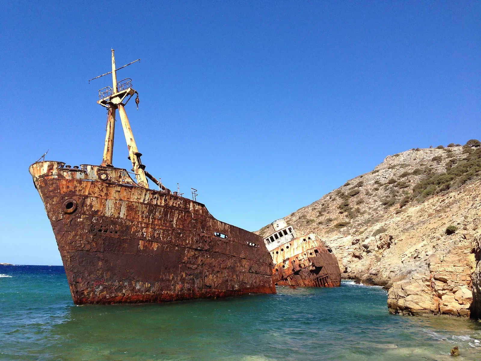 The rusting hull of a shipwreck run aground on the rocky coast of Amorgos.