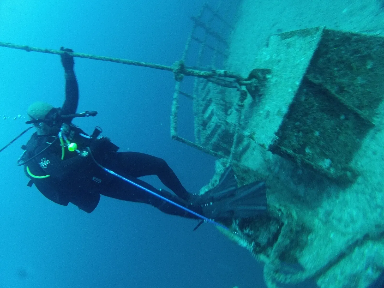 Diver working near the rudder and propeller of the sunken ship