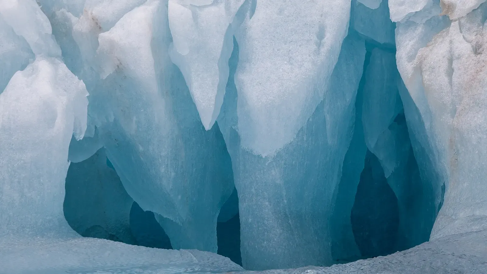 Weathered blue ice pillars and hollows on an iceberg face in Liefdefjord — Svalbard