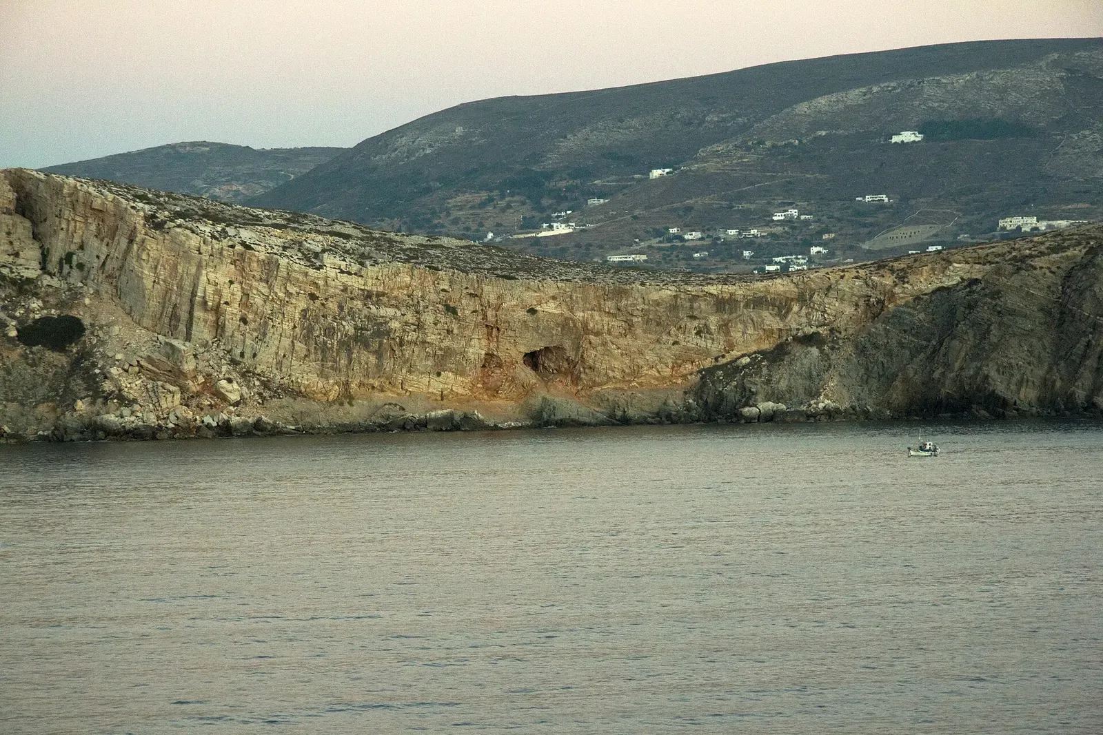 Rocky cliffs of Paros seen from the sea near the entrance to Parikia harbour