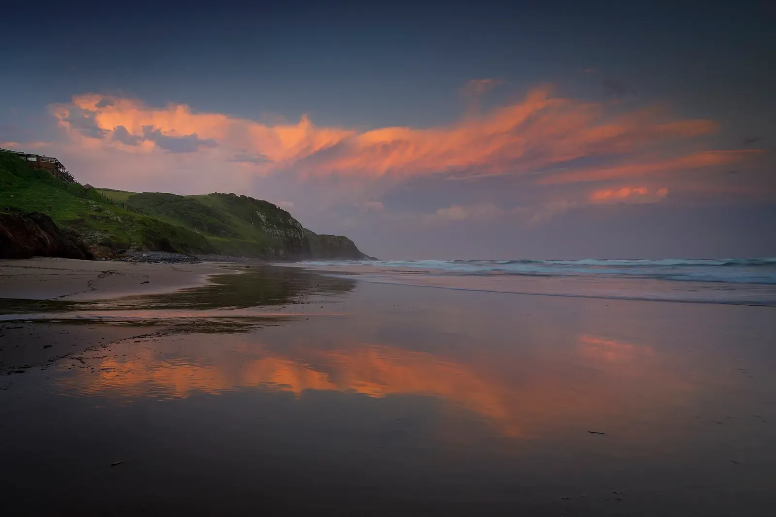 Sunset clouds reflected on wet sand at a beach near Coffee Bay — Sardine Run