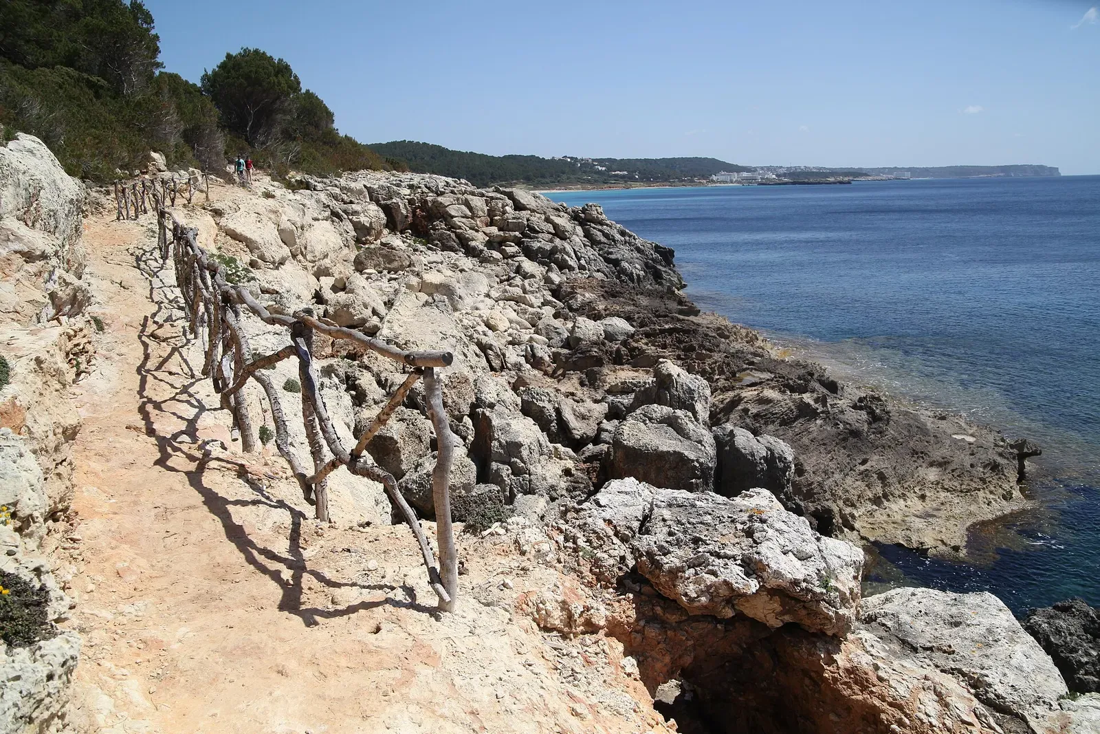 Rocky limestone coastal trail above the sea on Menorca's south coast