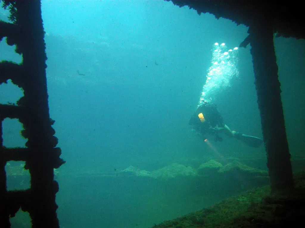 A diver descending into the cargo hold of the Sankisan Maru — Chuuk Lagoon
