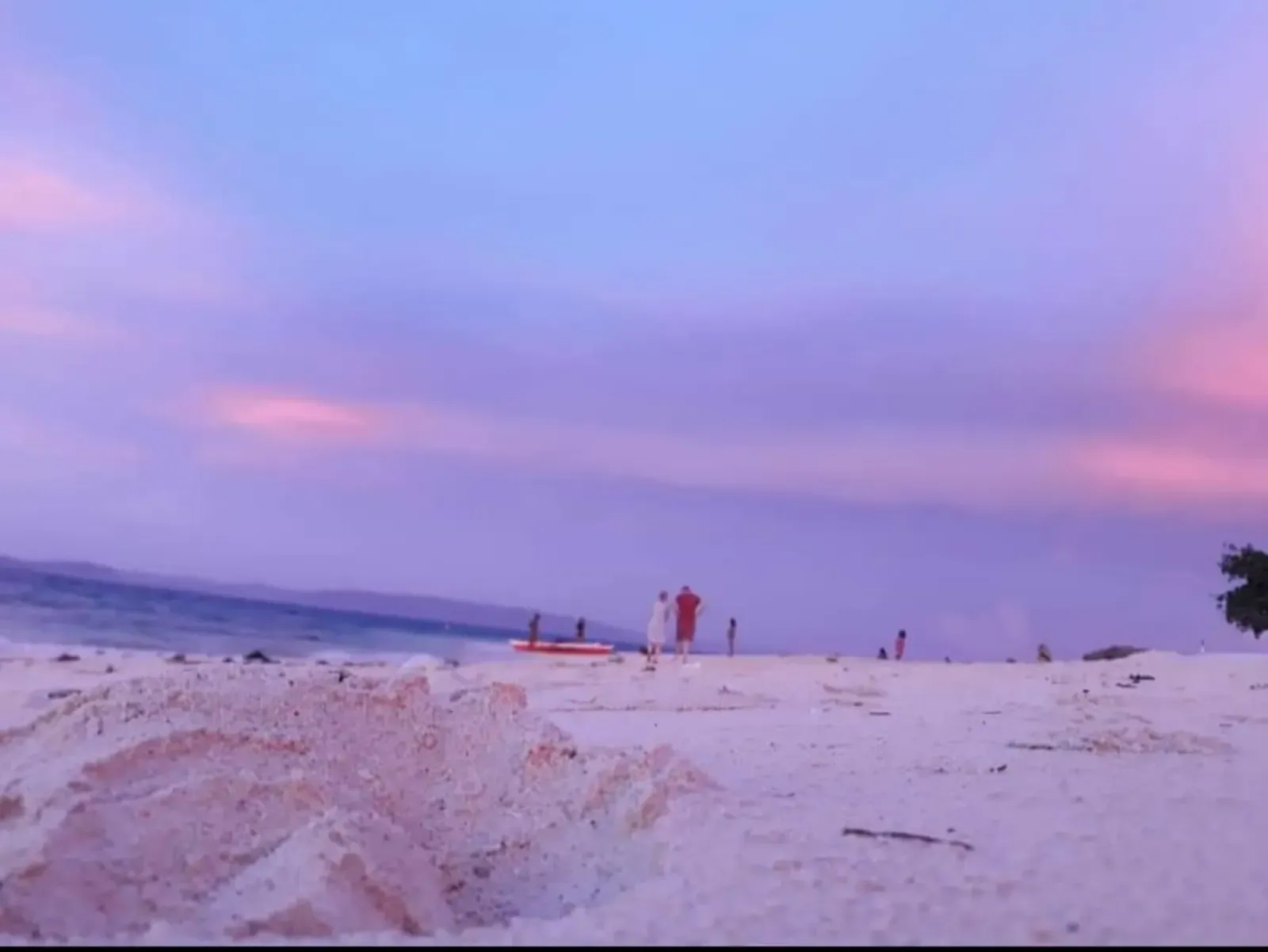 The white sand and shallow clear water along Pamilacan Island's shore