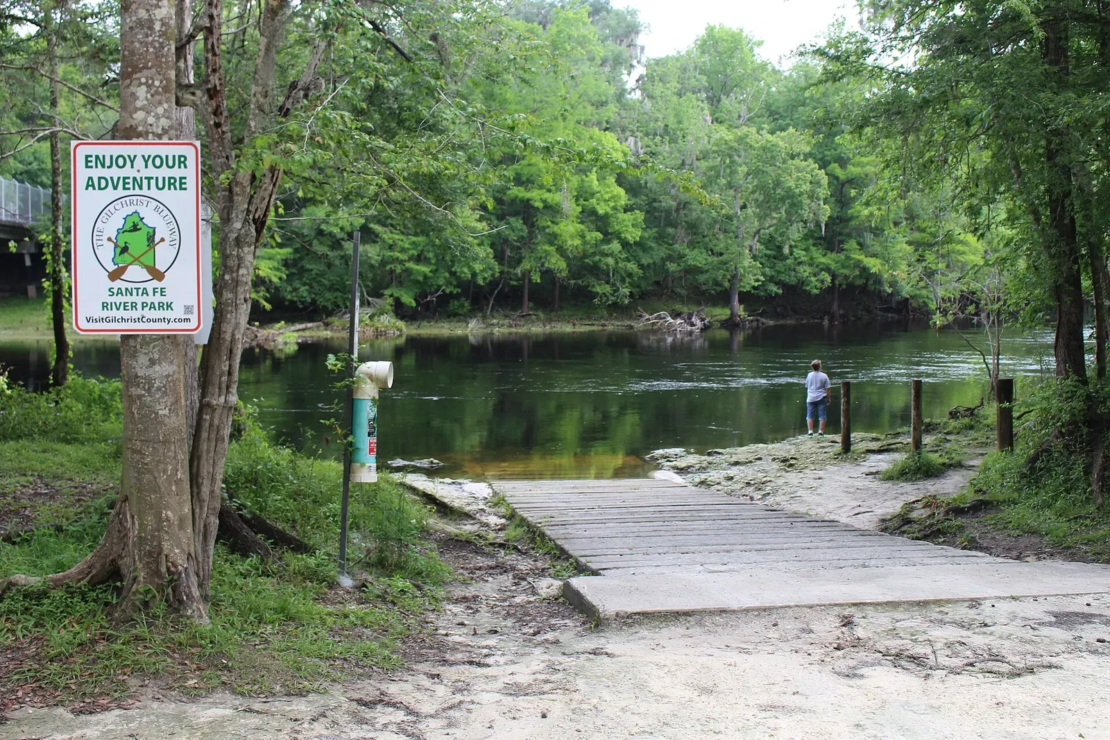 A boat ramp and dock lead into the tannic Santa Fe River at Santa Fe River Park — North Florida Springs