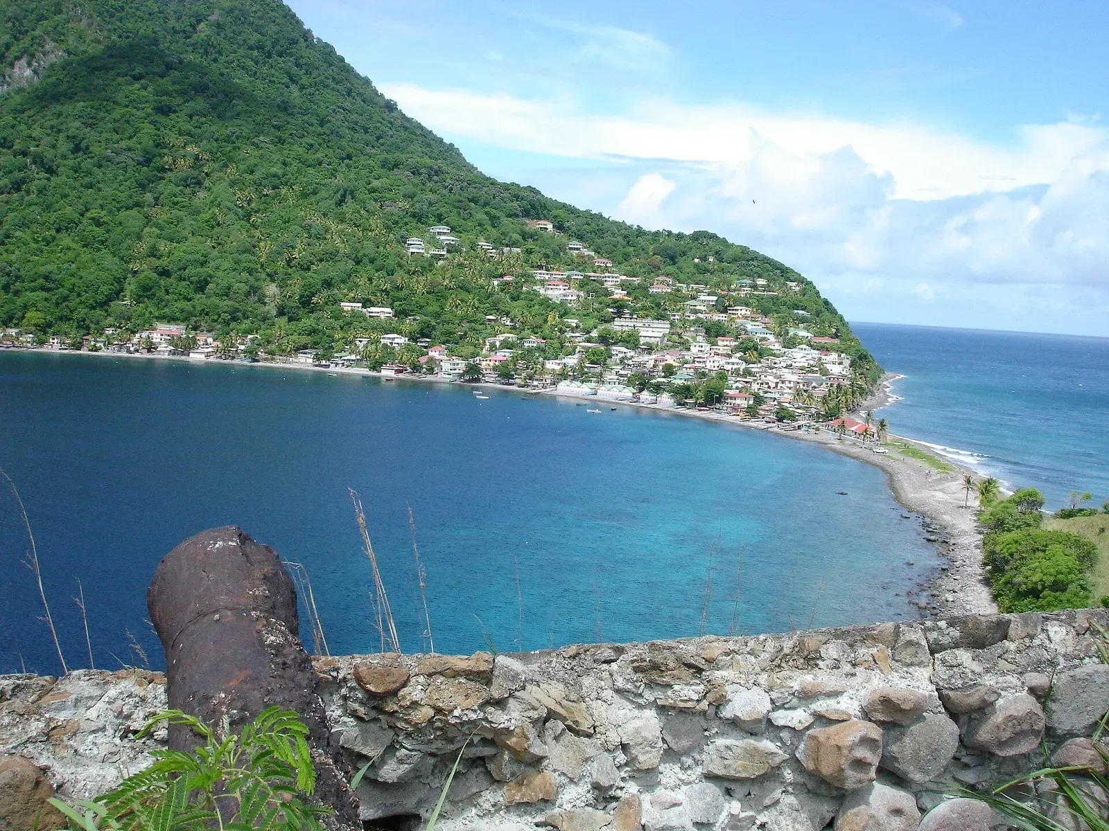 Old cannon at the ruined fort on Scott's Head overlooking the bay and dive site below — Scott's Head Drop-off, Dominica