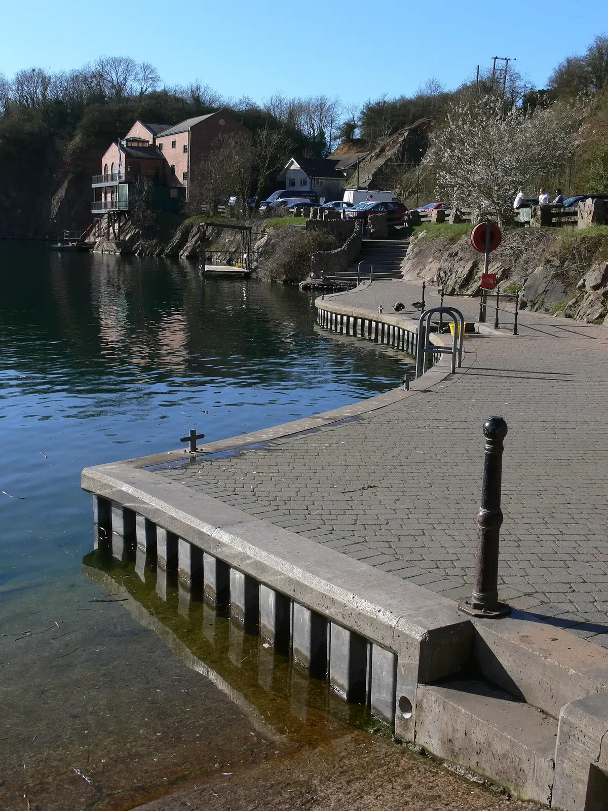 Paved dive platform and railings along the quarry's shallow entry edge
