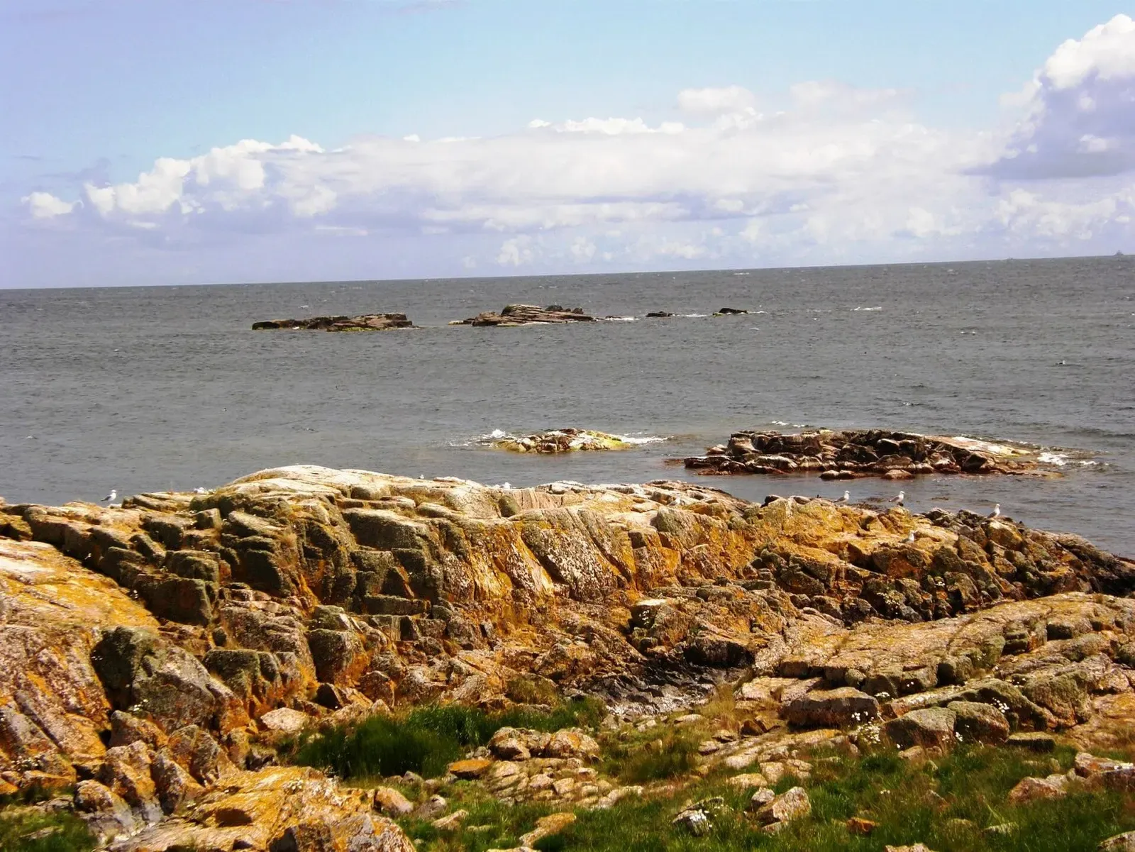 Weathered granite skerries breaking the surface east of Christiansø — Ertholmene, Bornholm.